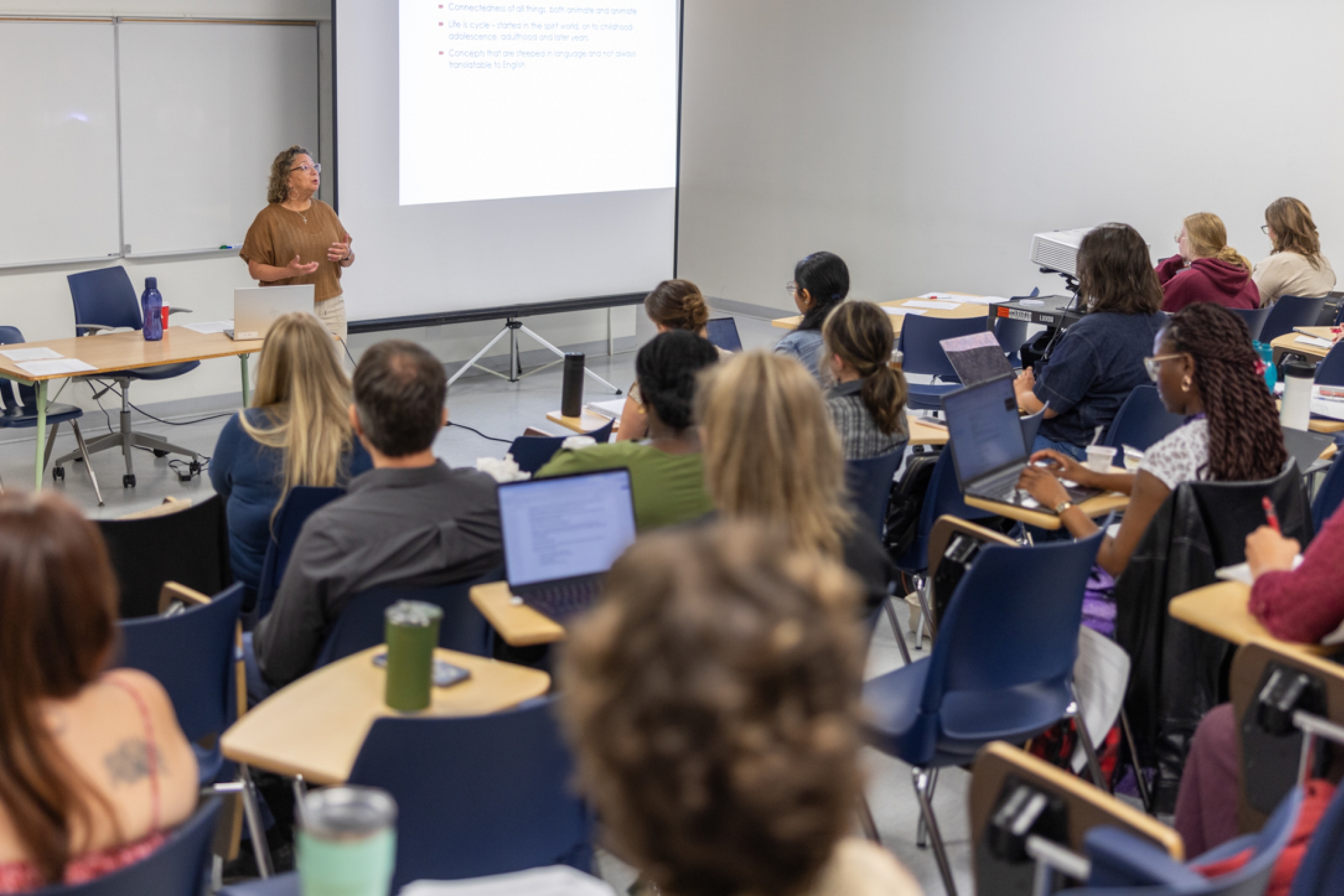 Students with an instructor in a classroom.