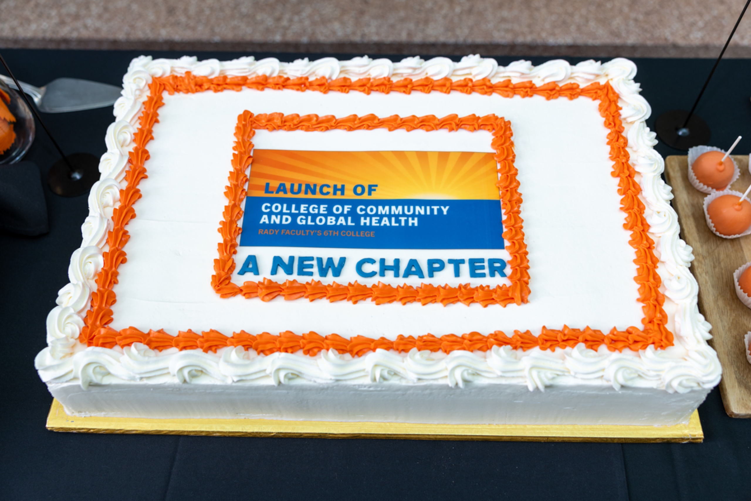 A cake with text: Launch of College of Community and Global Health, Rady Faculty's 6th college, a new chapter