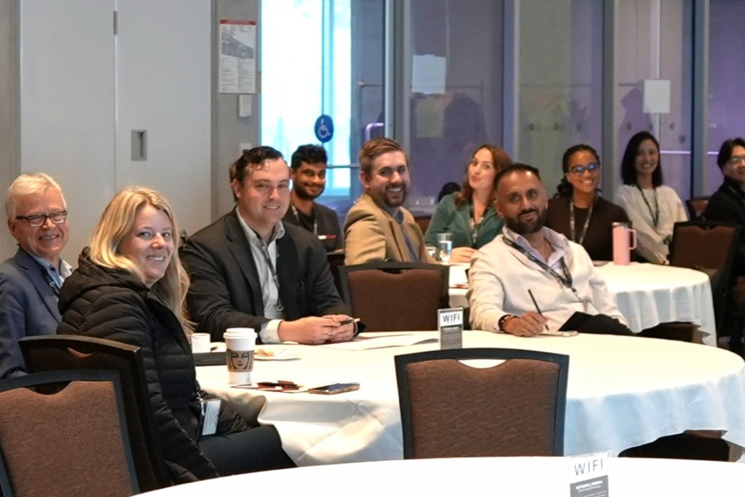 Images of guests sitting around conference tables.