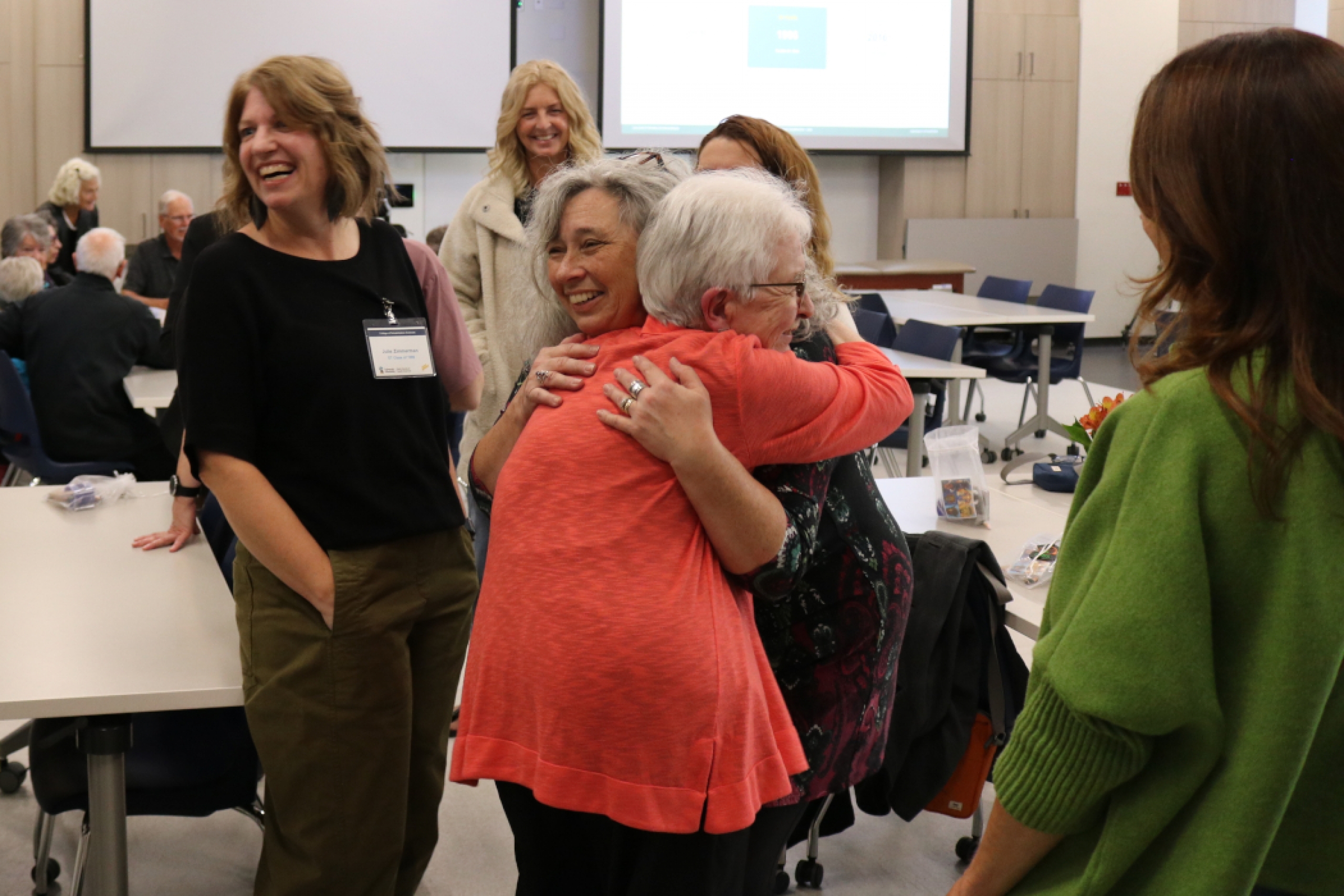 Two people hug. 
