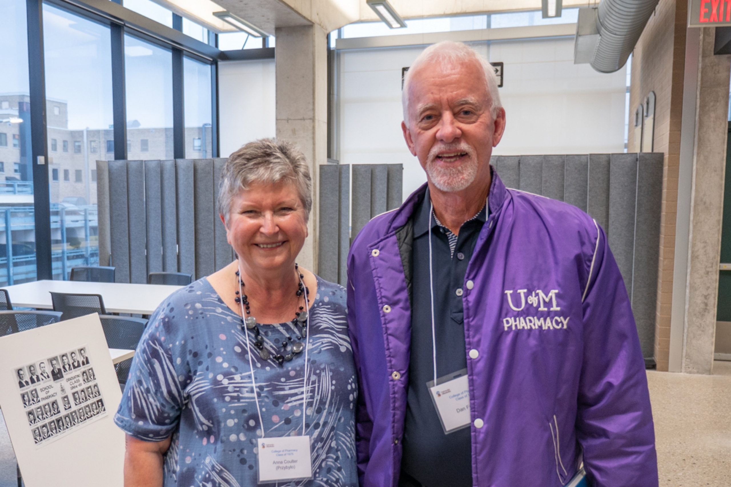 Two College of Pharmacy alumni pose at a Homecoming tour.