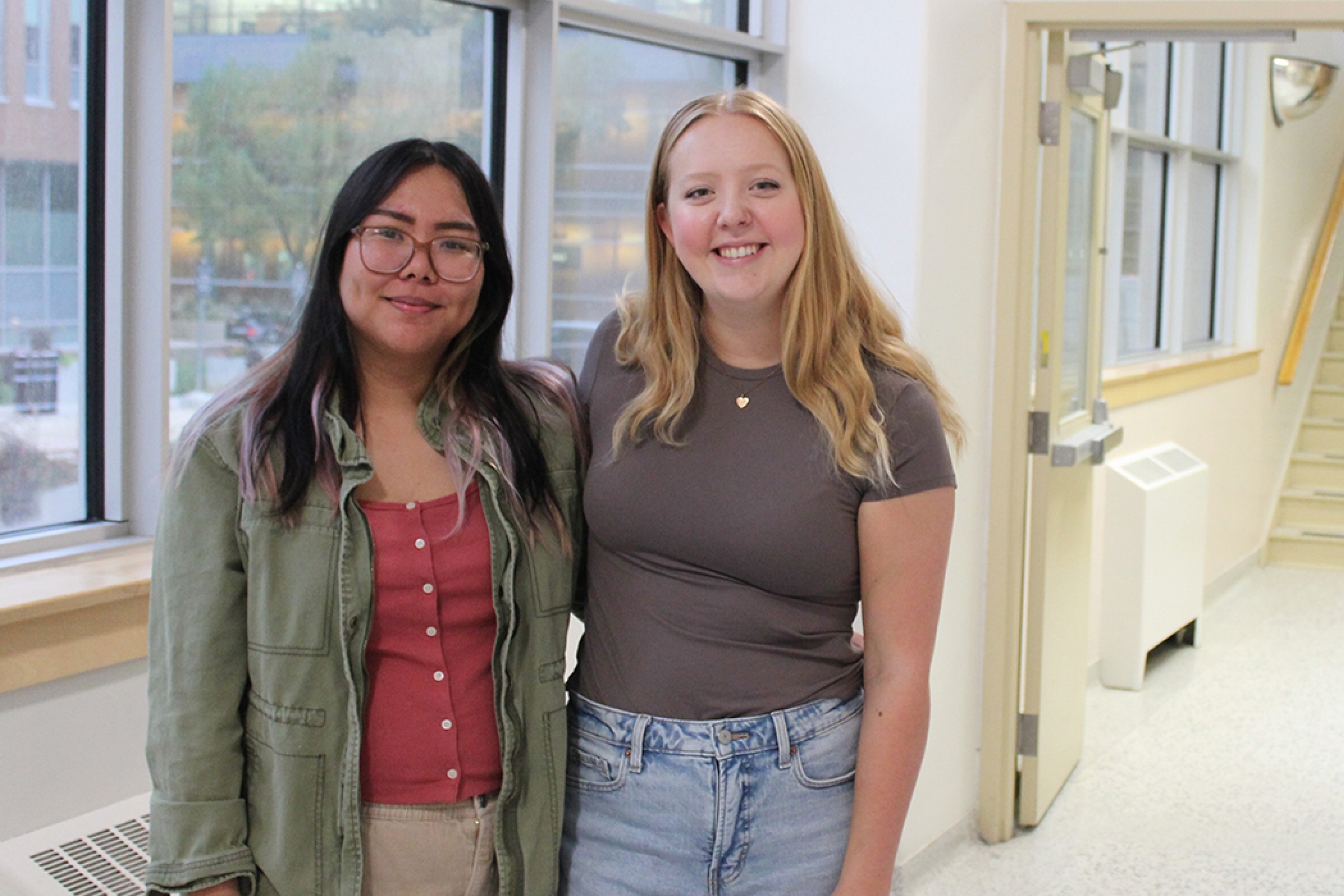 Czynara Gerard Patio and Maya Blair standing in a hallway at the College of Rehabilitation Sciences.