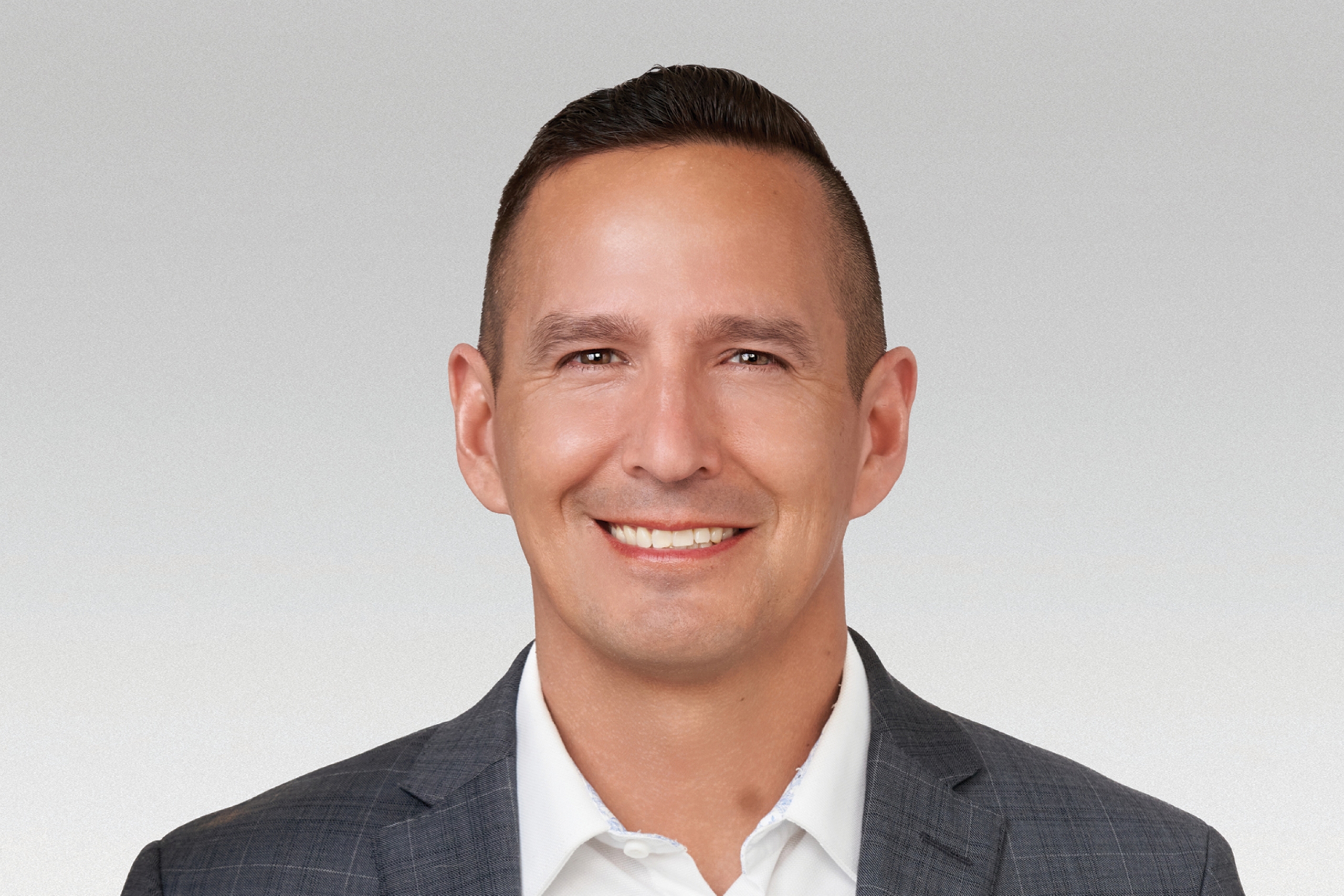 Headshot of a smiling man.