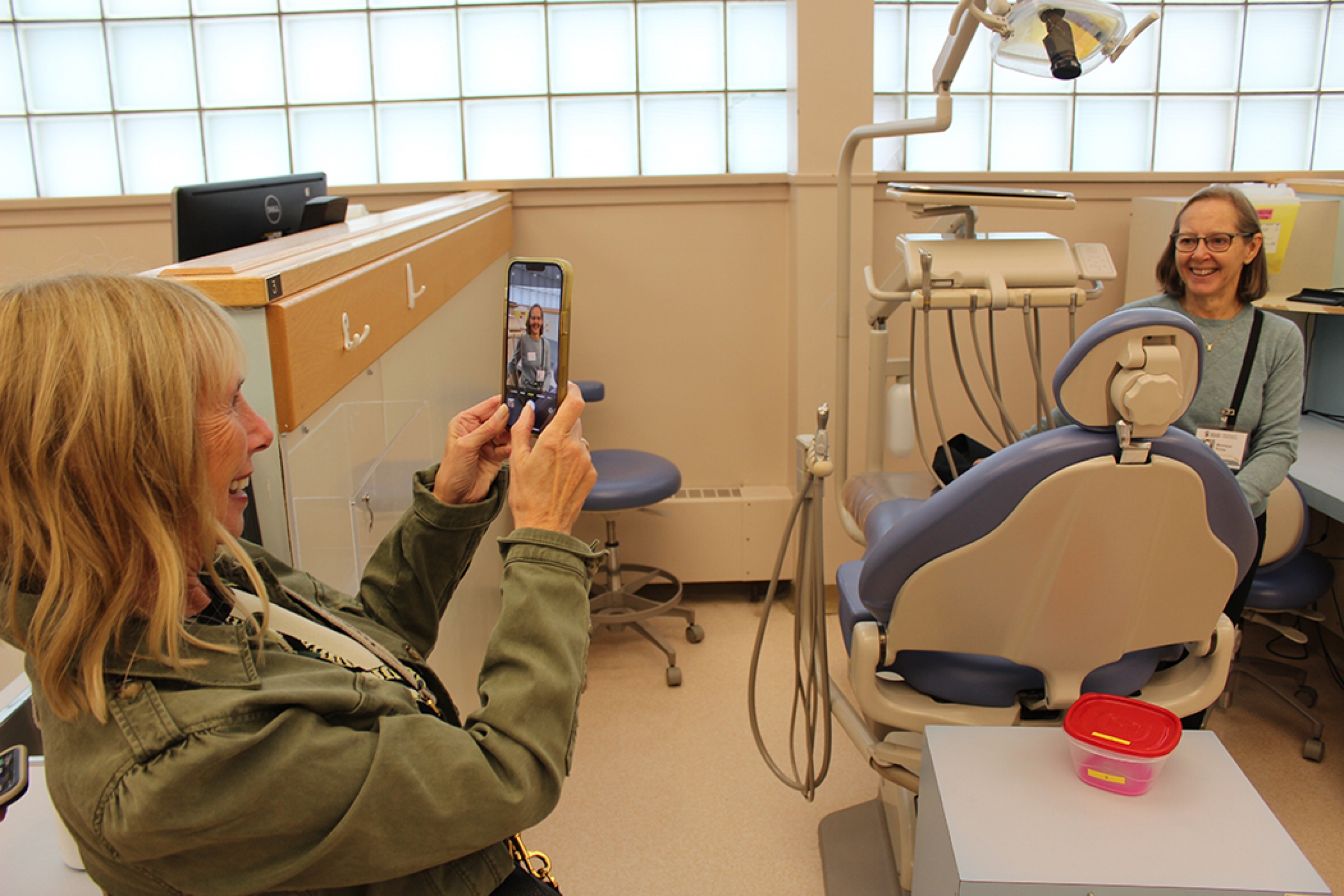Dentistry alumni taking photos inside the UM dentistry facilities during a homecoming tour.