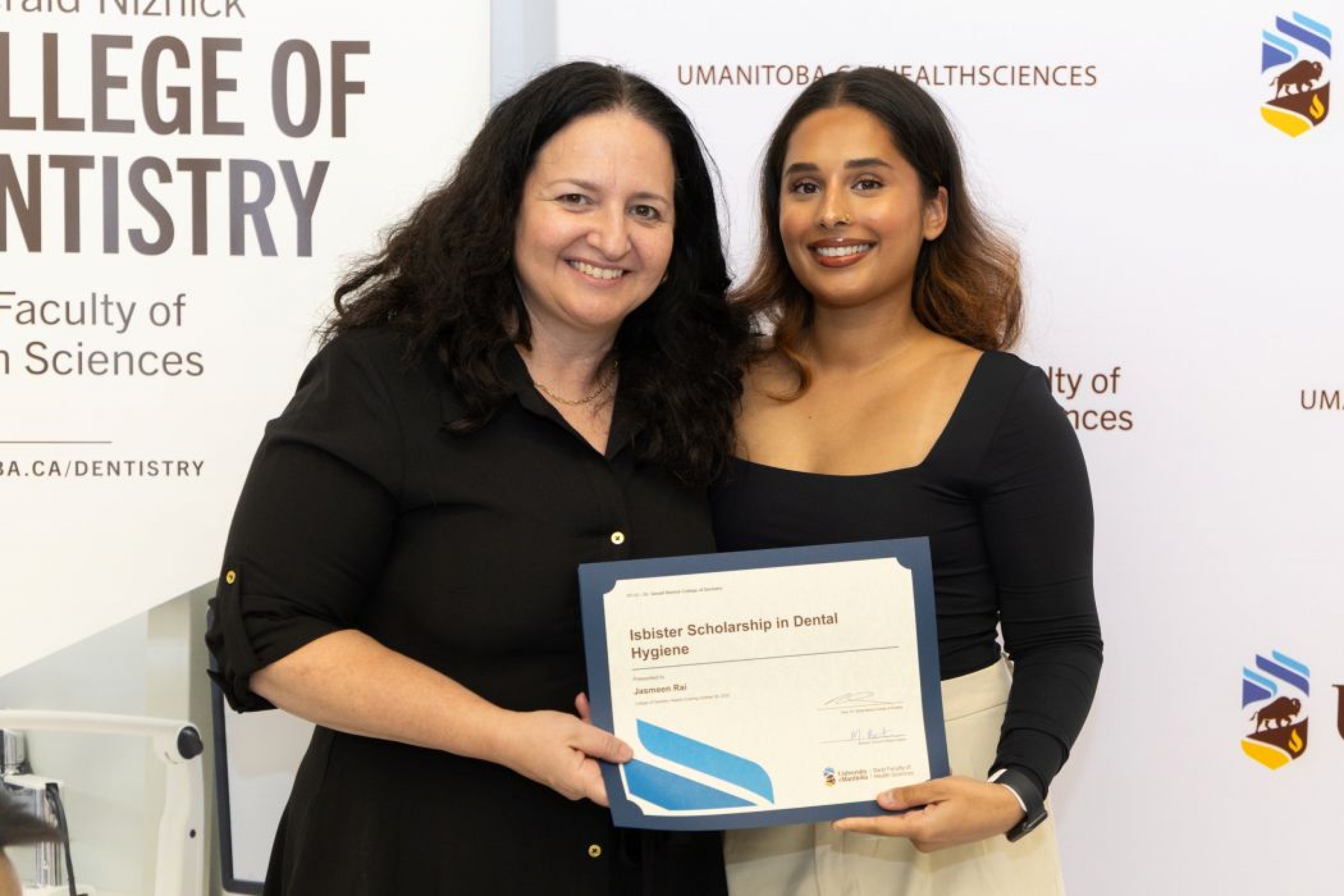 One person presents a certificate to another person.