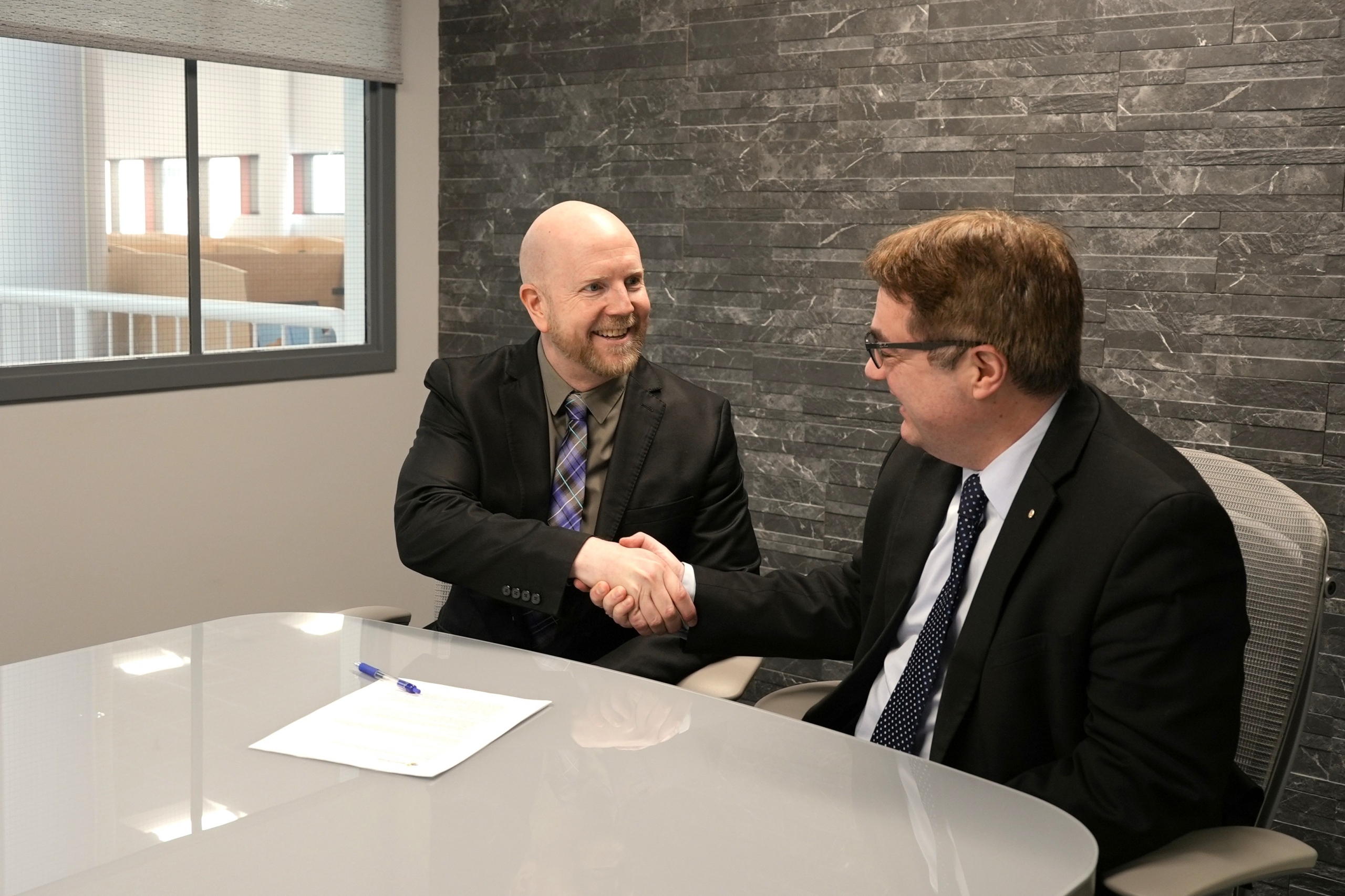 Derek Earl shakes hands with Dr. Bruno Silvestre
