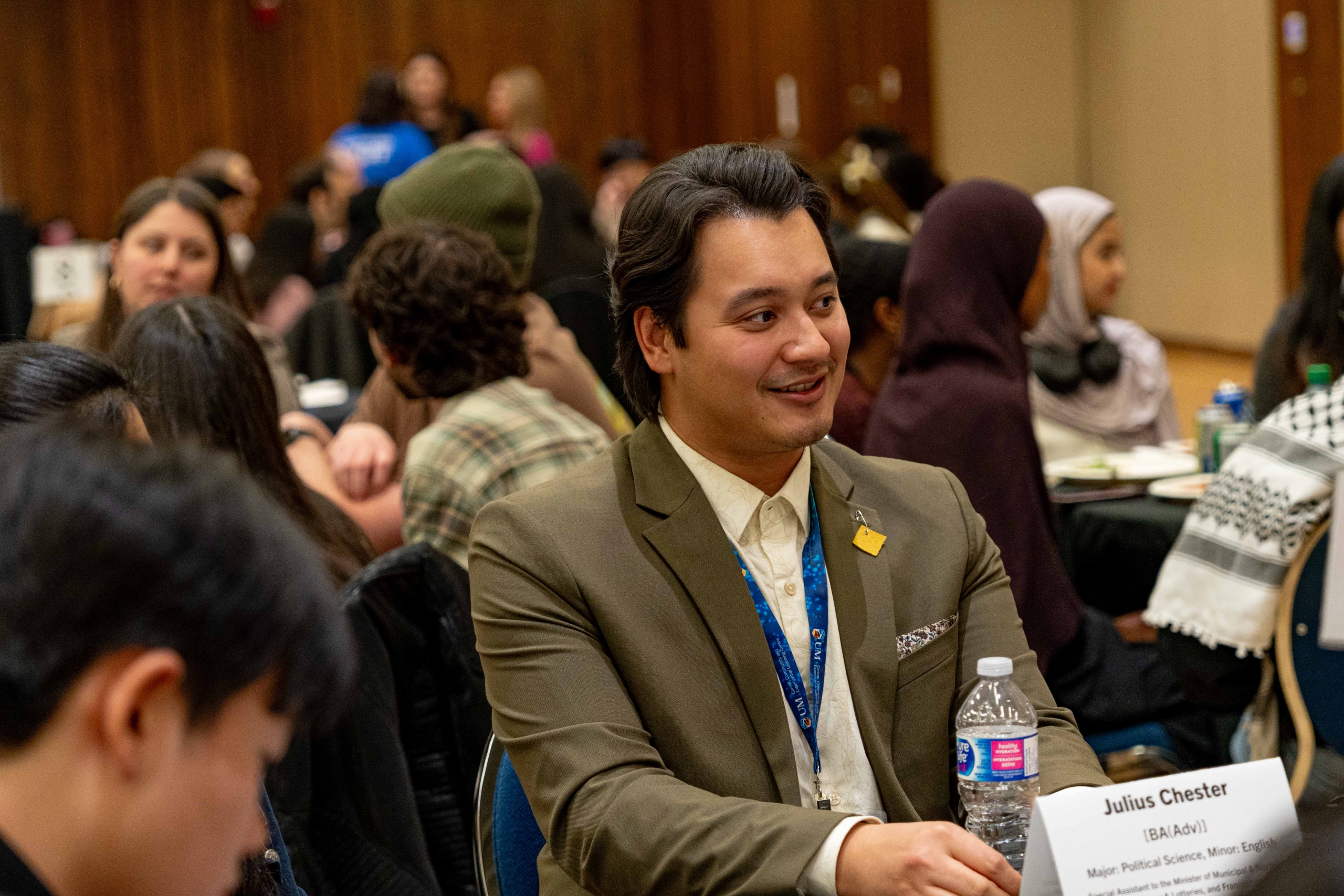 A man sitting at a table smiling.