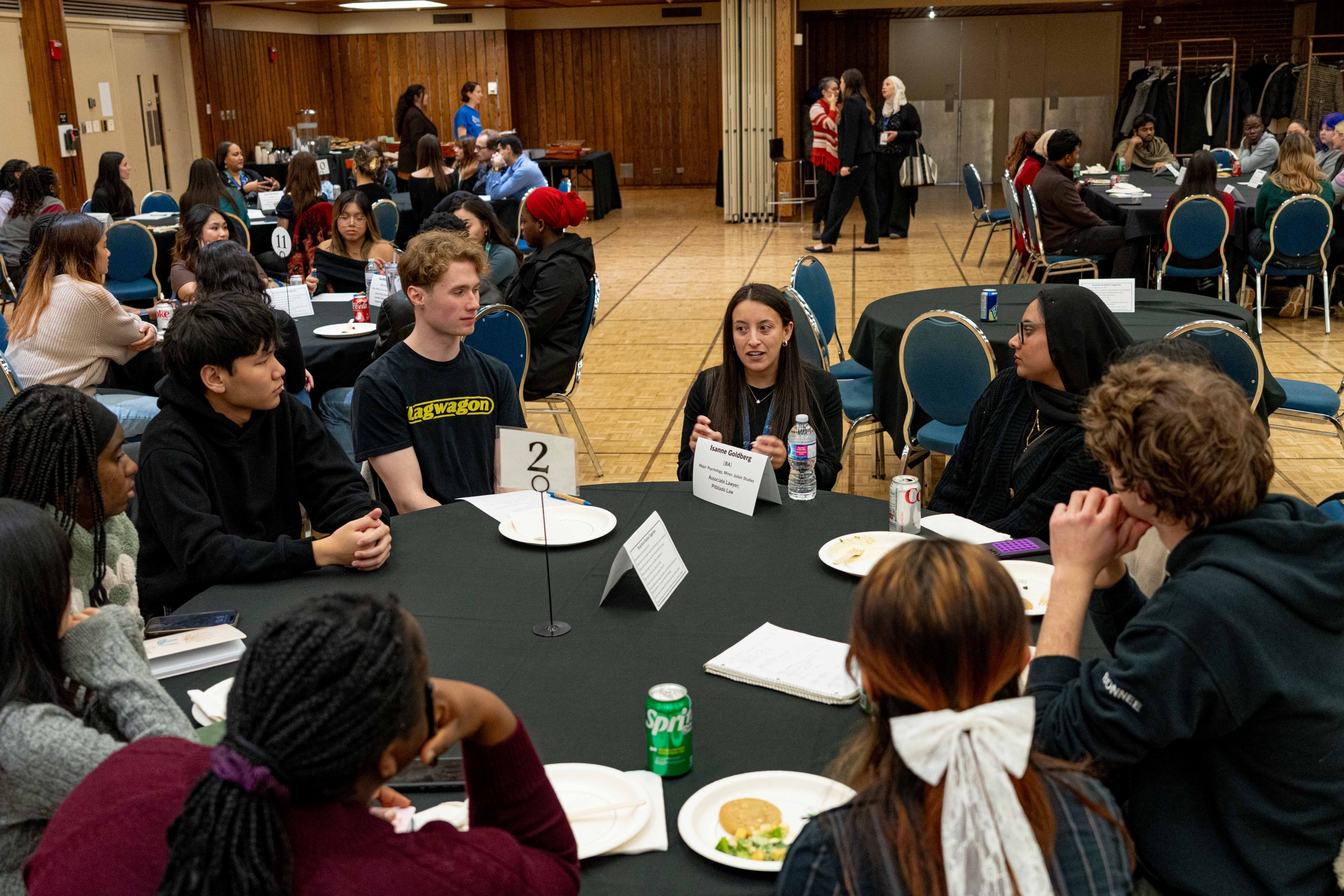 A table of students plus one alumni.