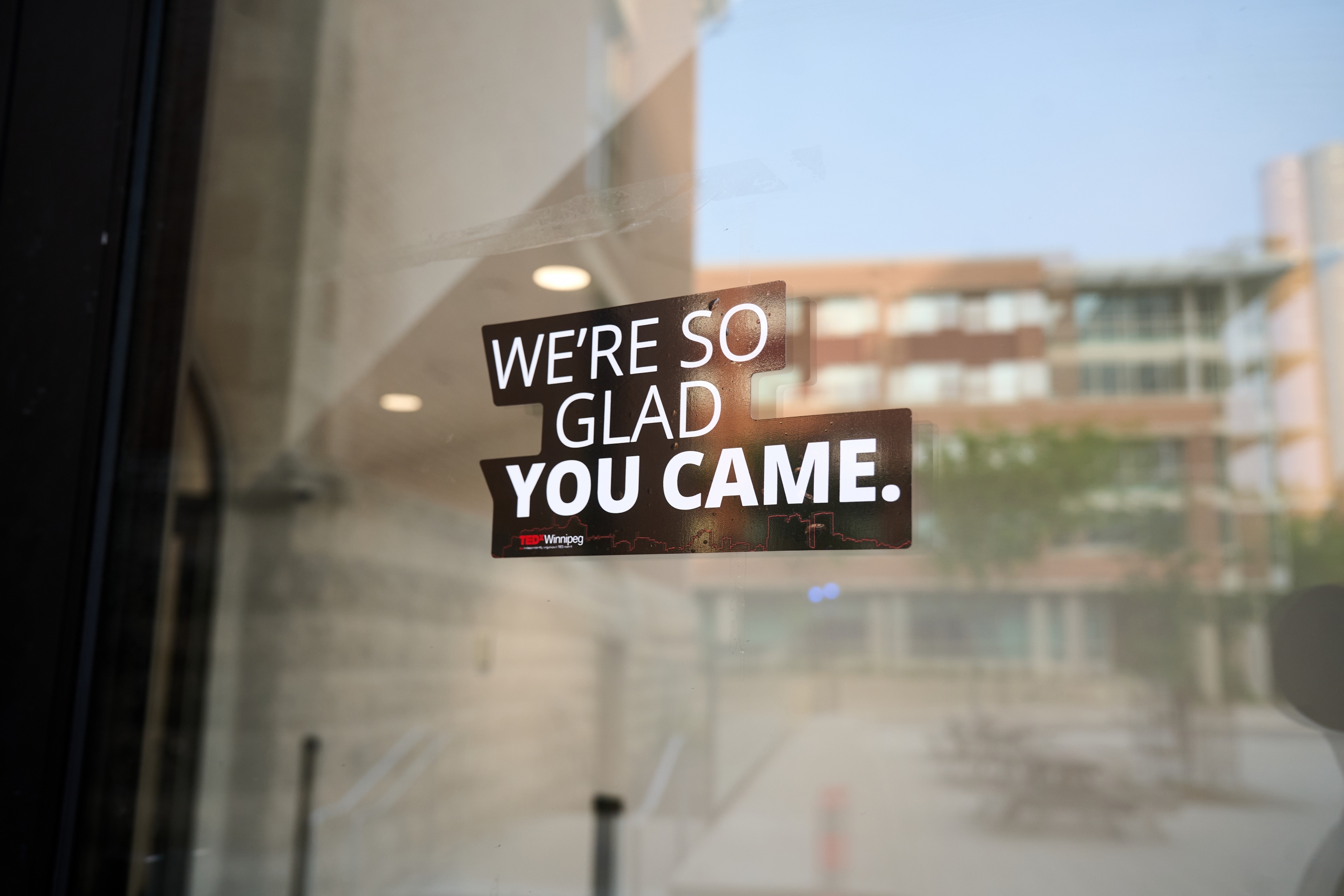 Sticker on door that reads: We're so gald you came