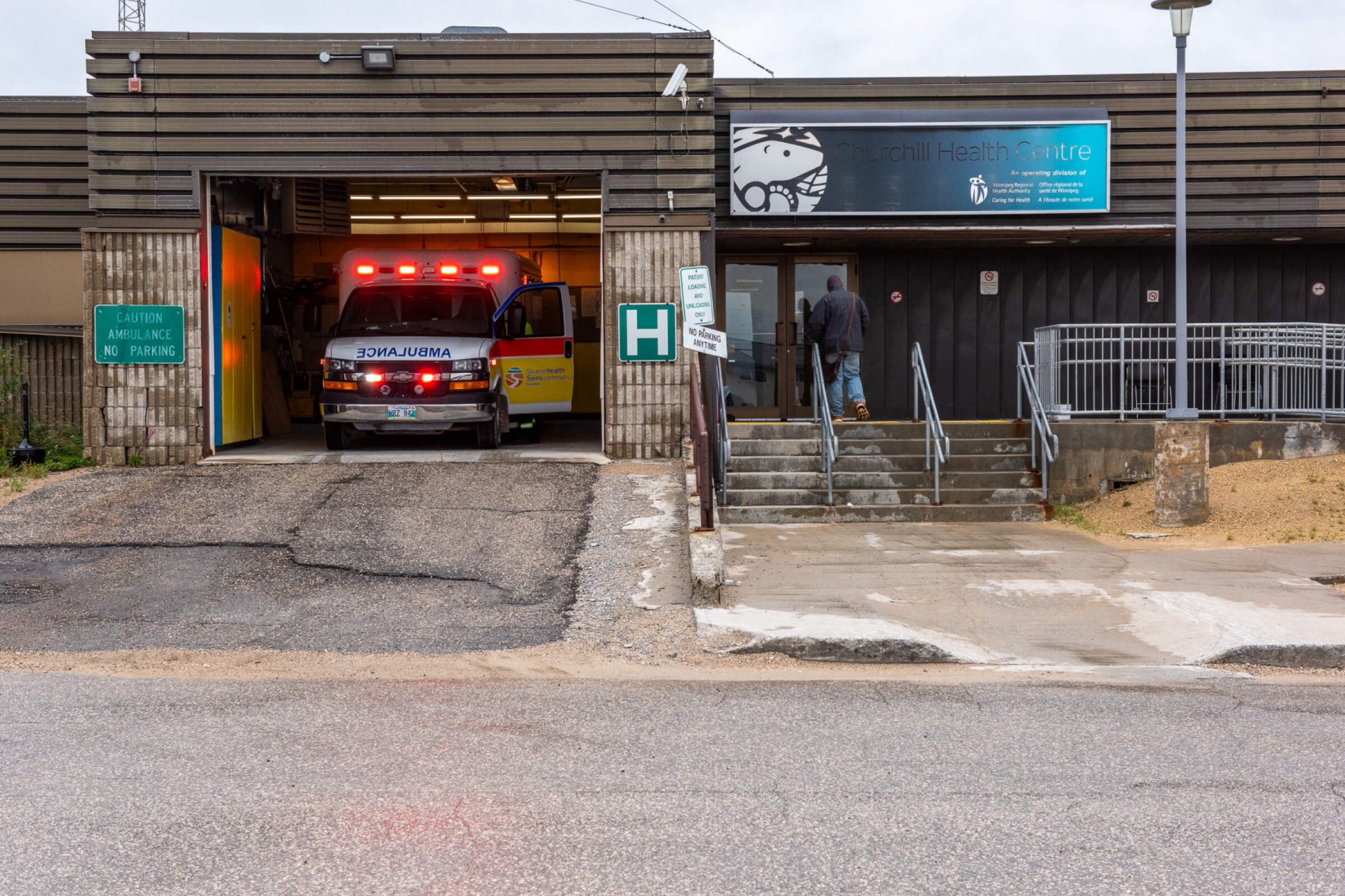 A person walks into the Health Centre.