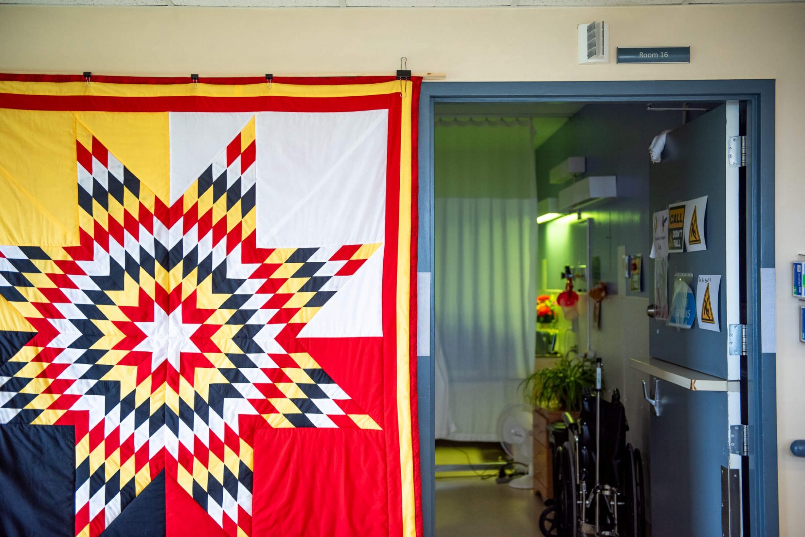 A blanket hangs on the wall.