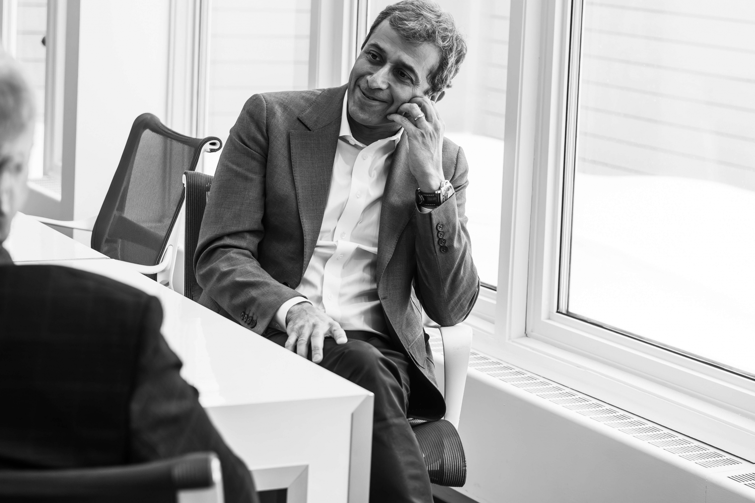 A man sitting in a chair smiling
