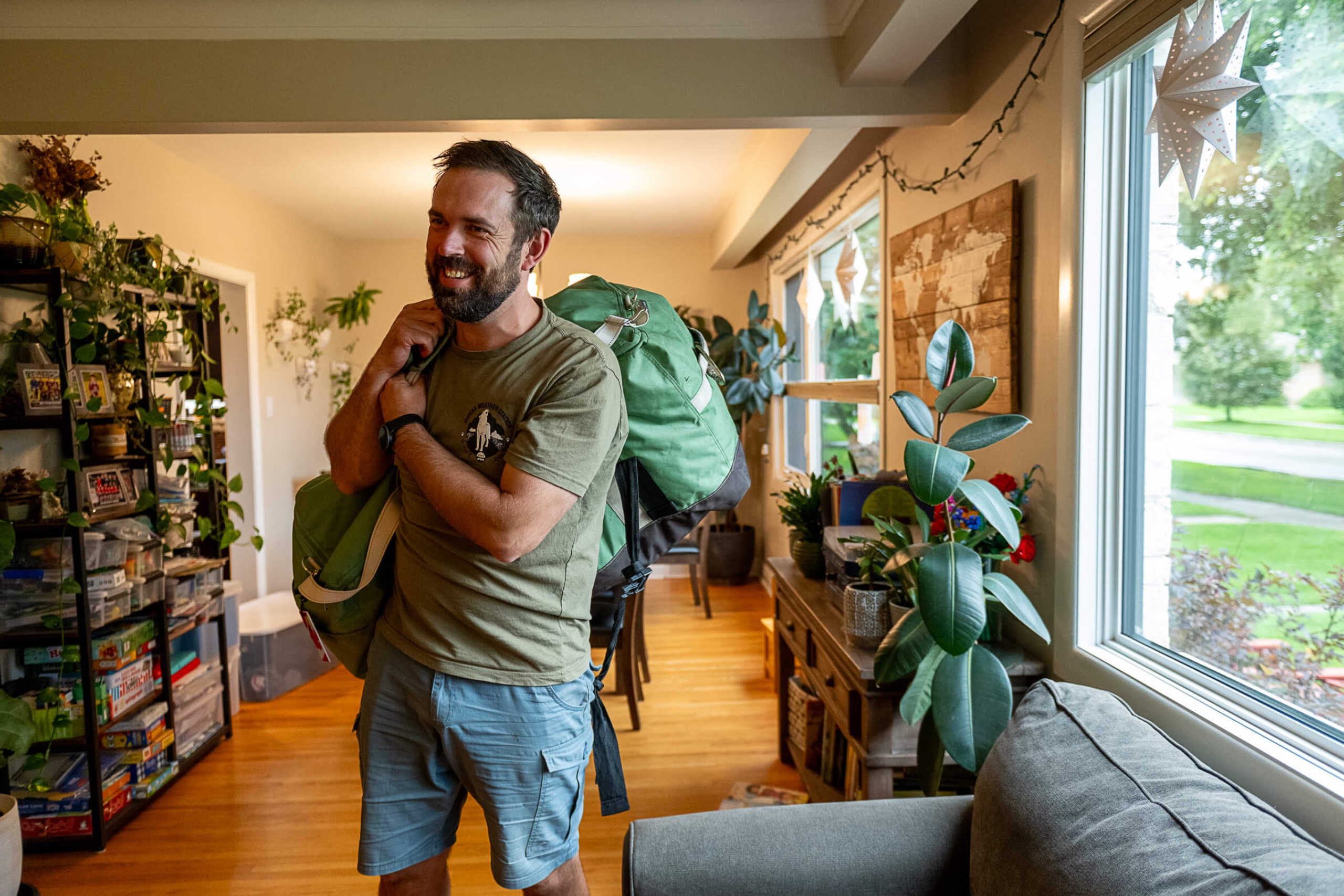 A researcher holding a bag on his shoulder