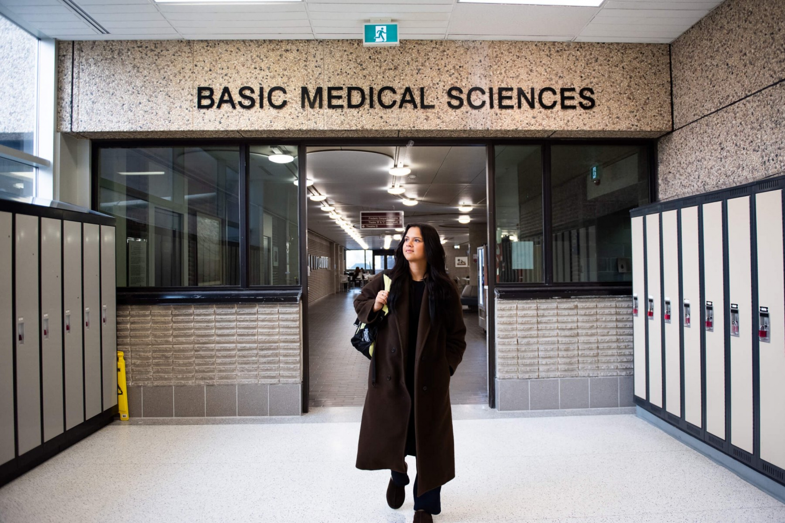 A woman walks down a hall