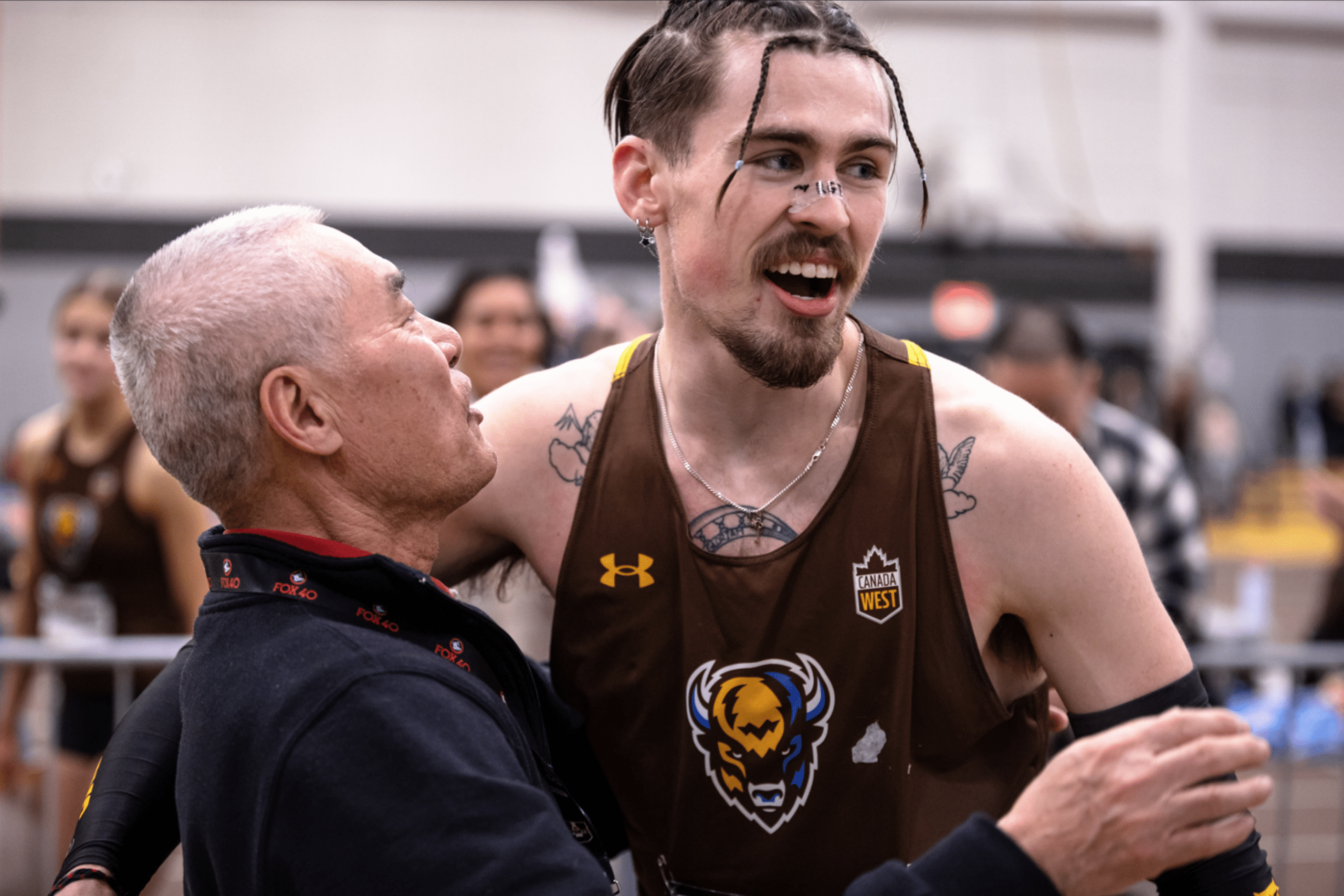Daxx Turner and coach Mingpu Wu celebrating after a race