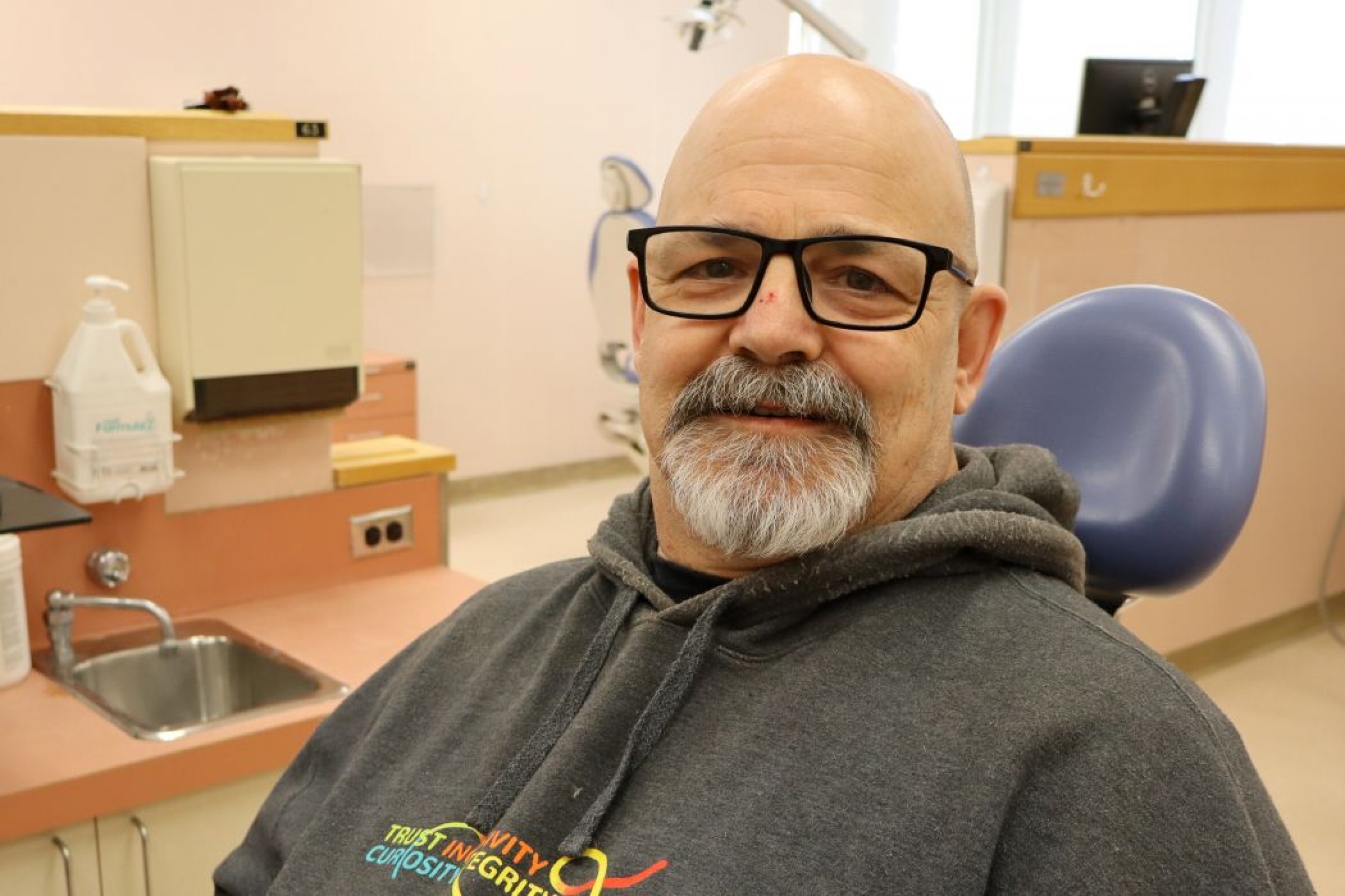 Portrait of Mike Wesa in a dental chair. 