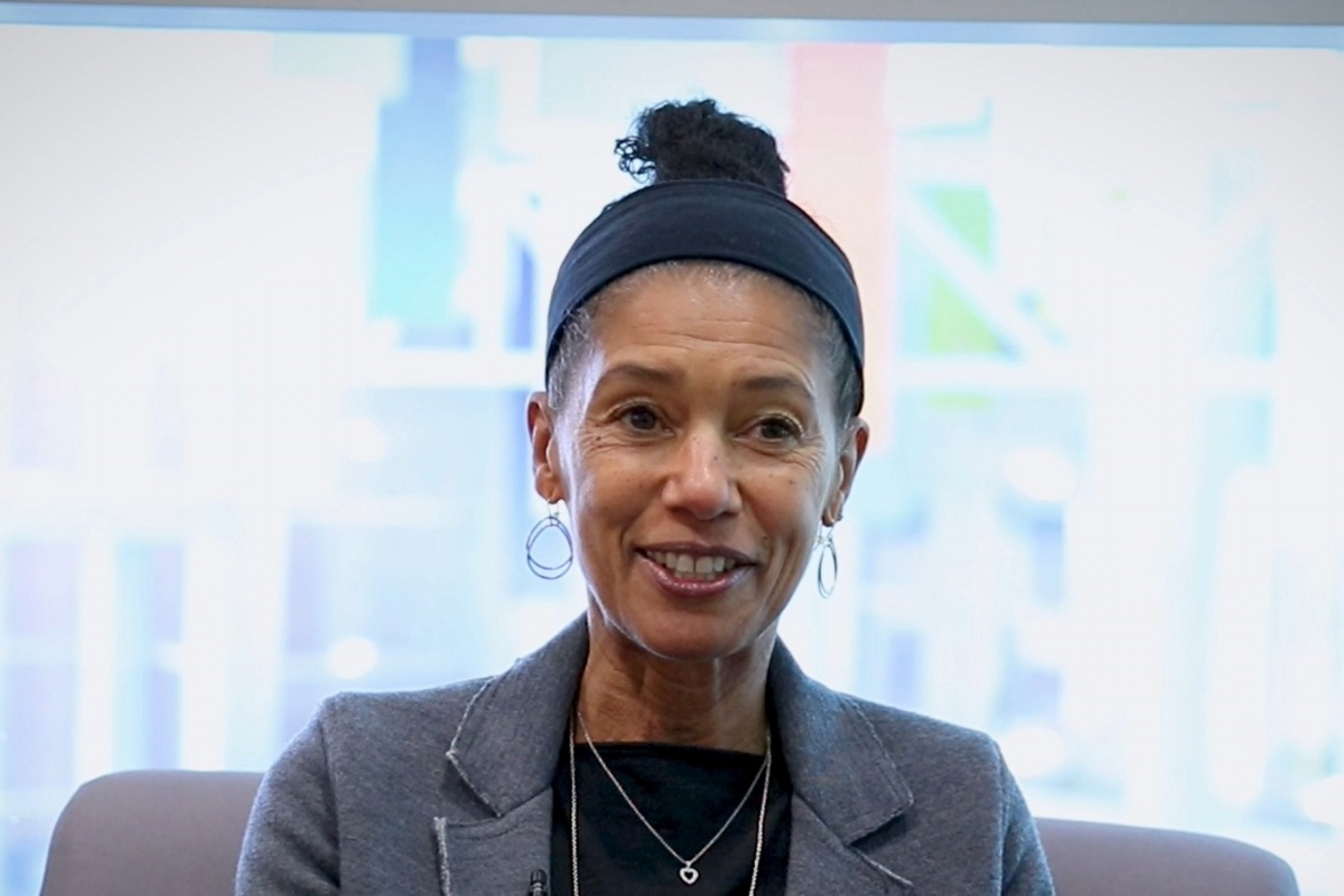 Dr. Delia Douglas smiling while looking away from the camera.