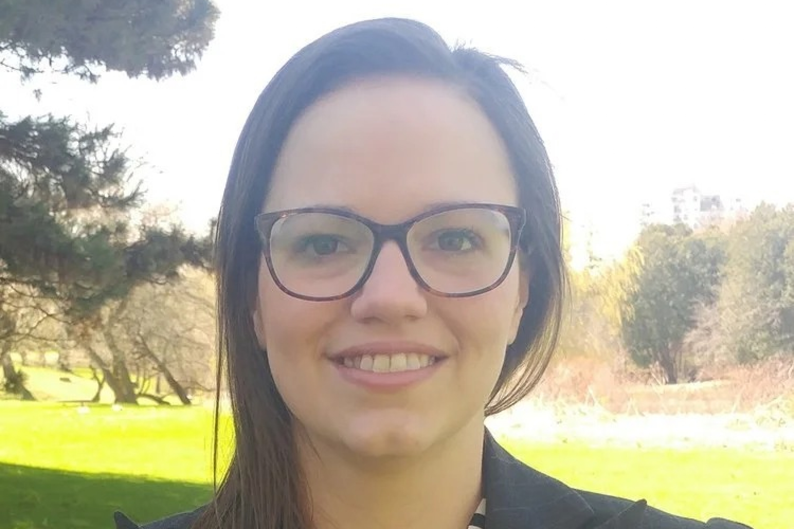 Woman smiling outside.