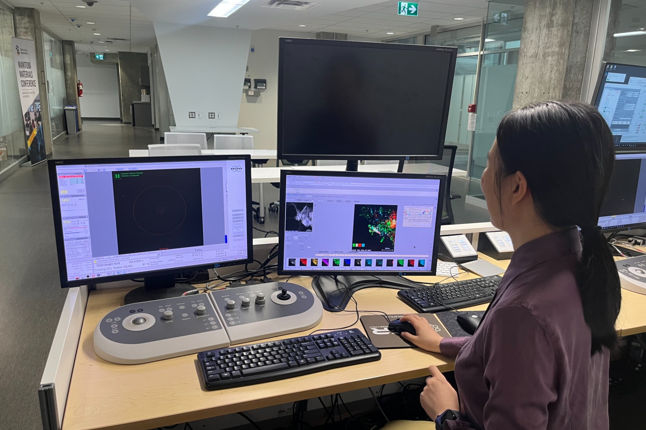 Dr. Guozhen sitting and inspecting images on her setup