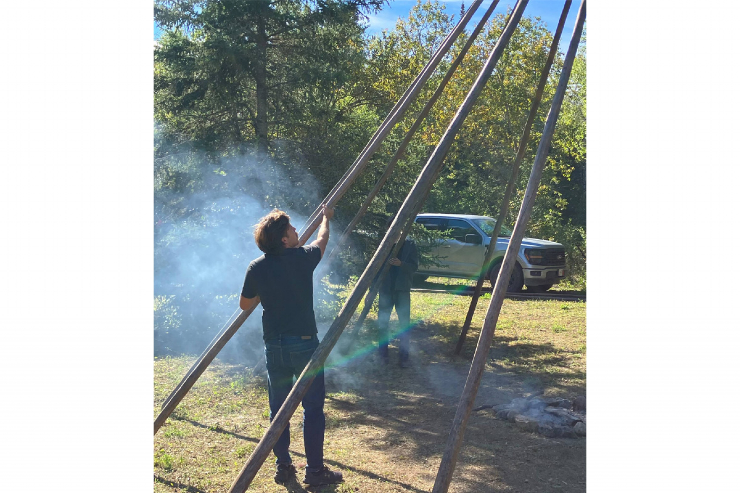 A student helps take down a structure at a sundance.