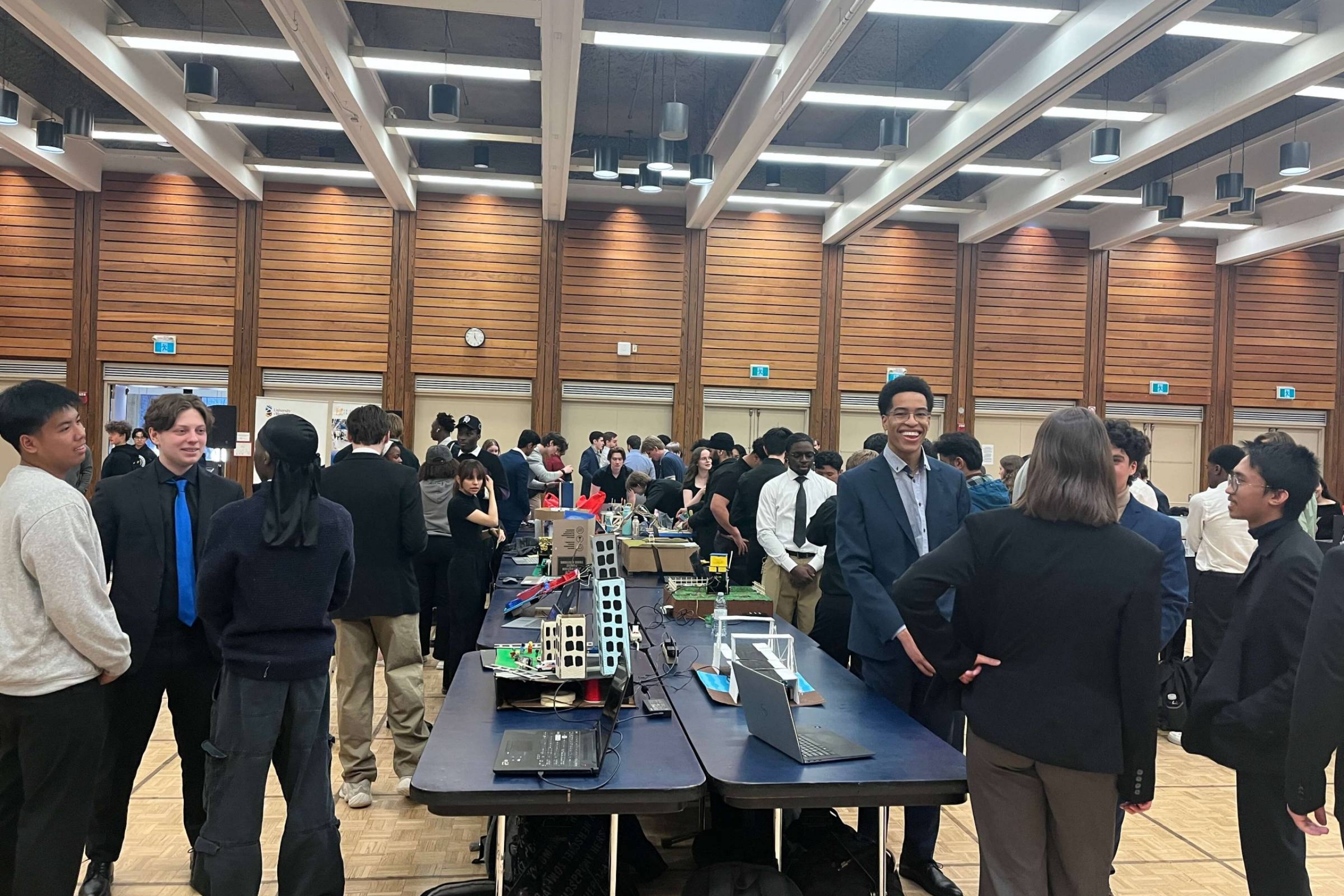 prototypes set up on tables surrounded by students