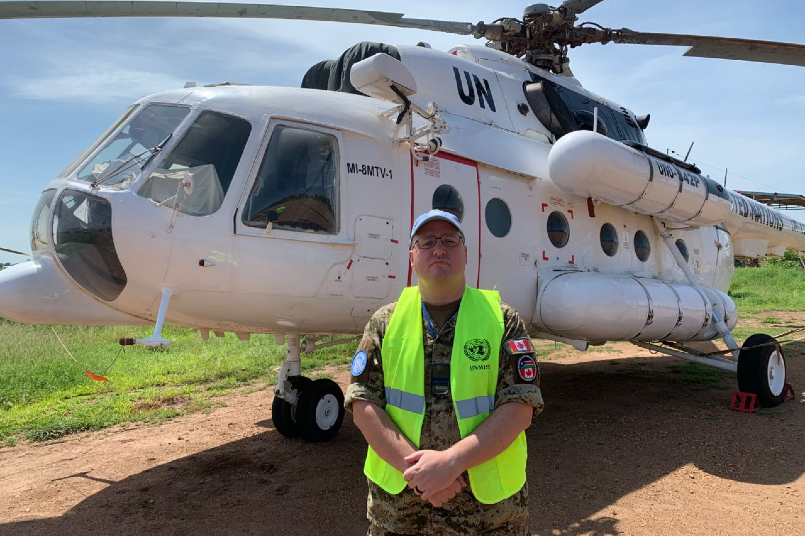 A man in front of a helicopter