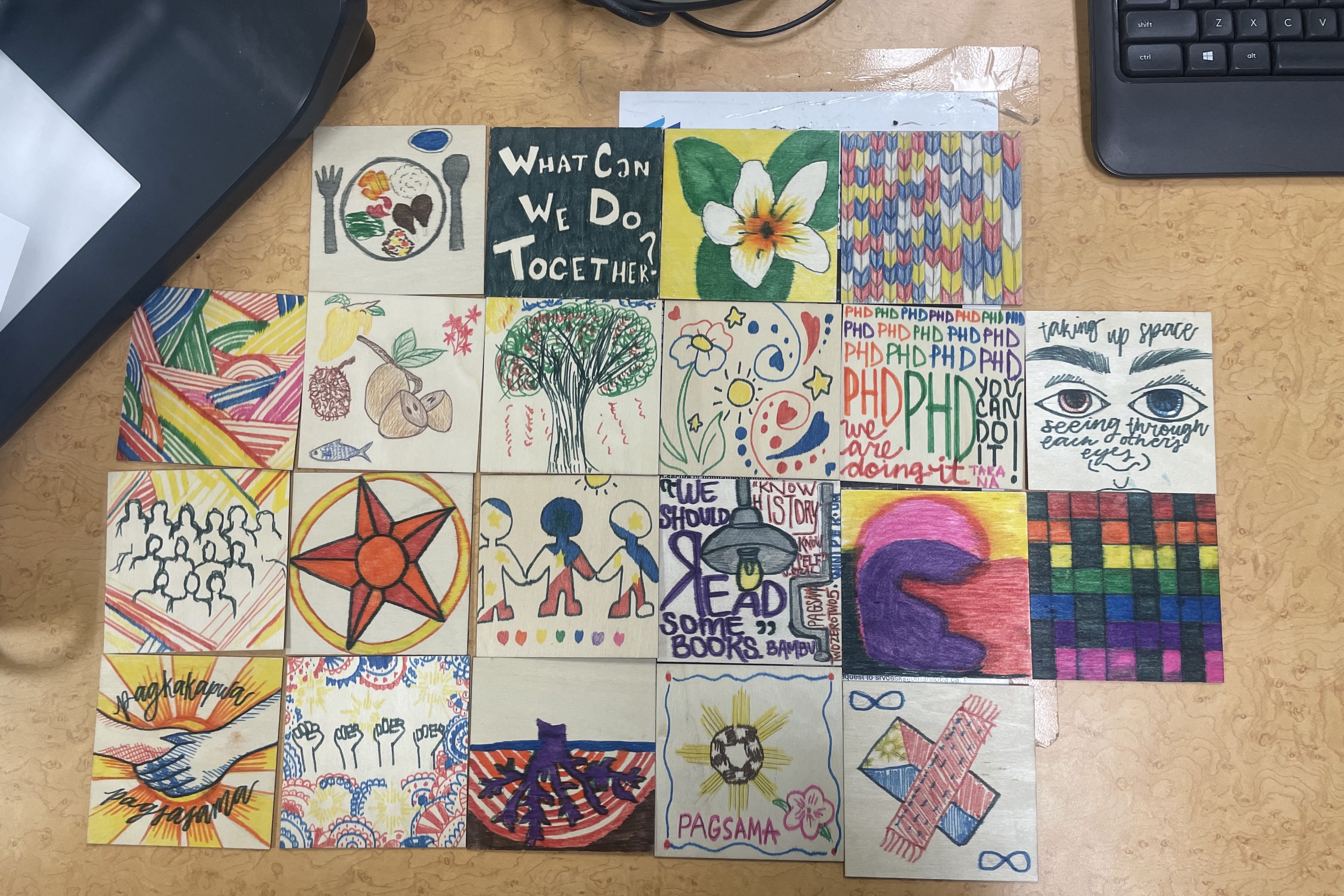 members art pieces connected together in a grid on a desk