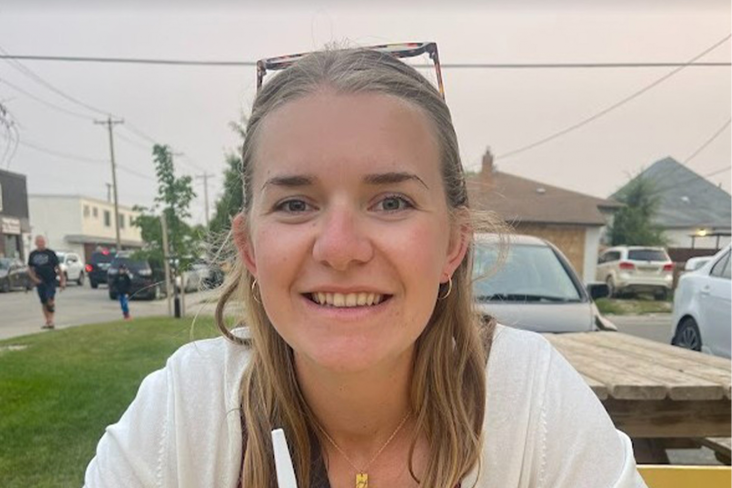 Kaitlyn Klassen smiling while sitting outside