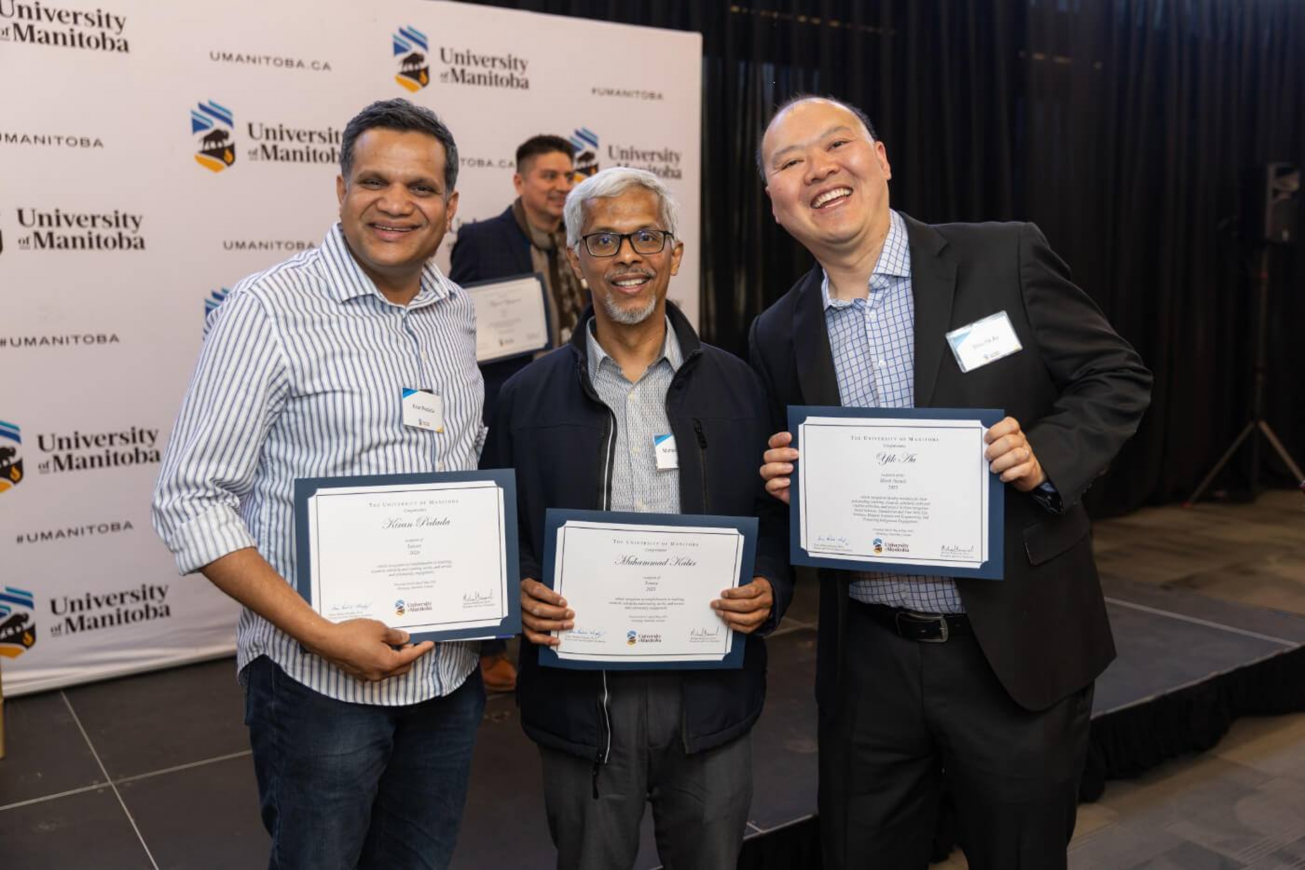 Kiran Pedada, Muhammad Kabir, and Yik Au with their award certificates