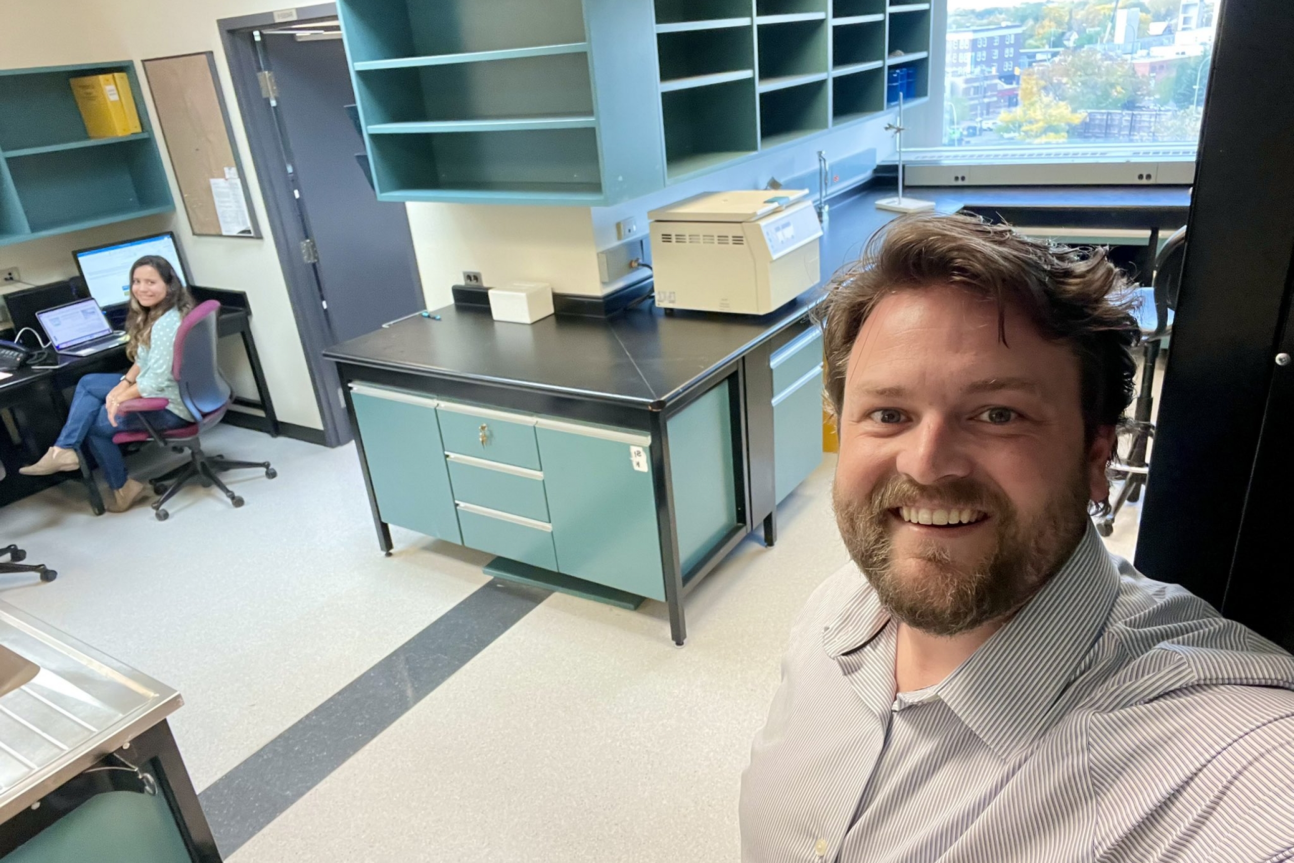 Dr. Henry A. Dunn takes a selfie with a researcher in his lab.