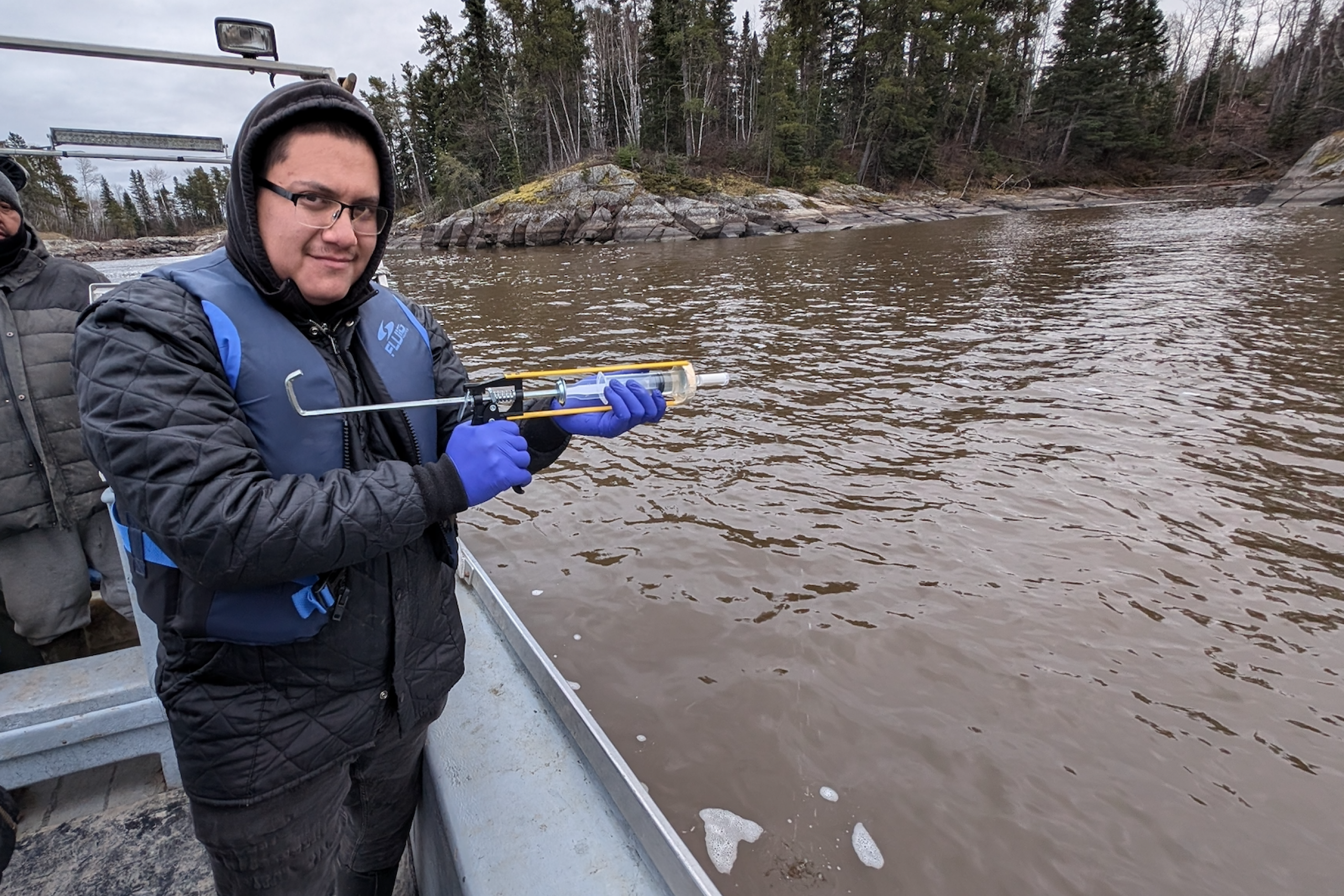 Seth using the eDNA kit to gather a syringe filtered sample. 