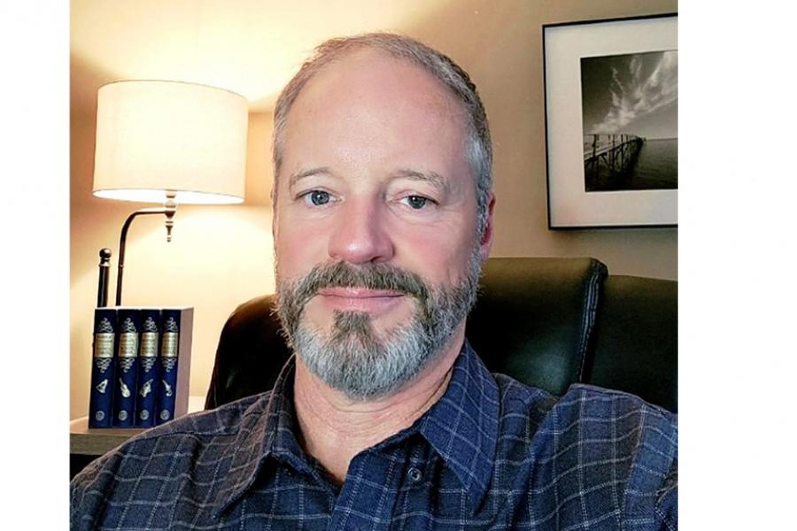 A headshot of Frank Cormier in a home office.