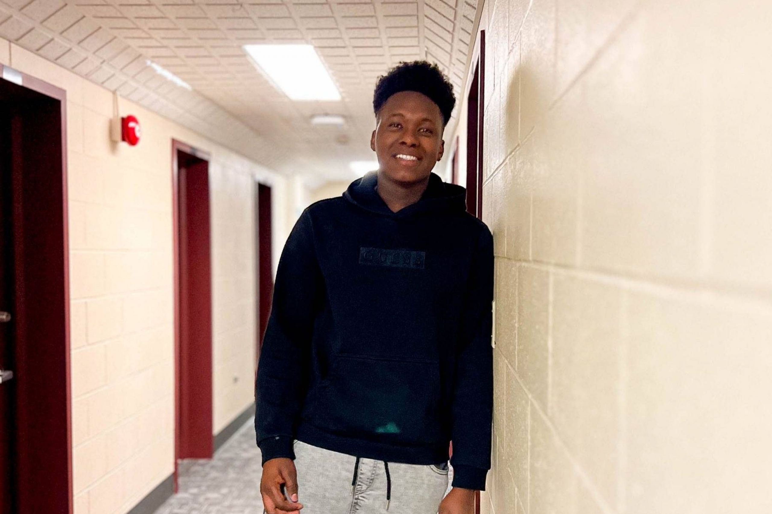 Student standing in the hallways of St John's Residence