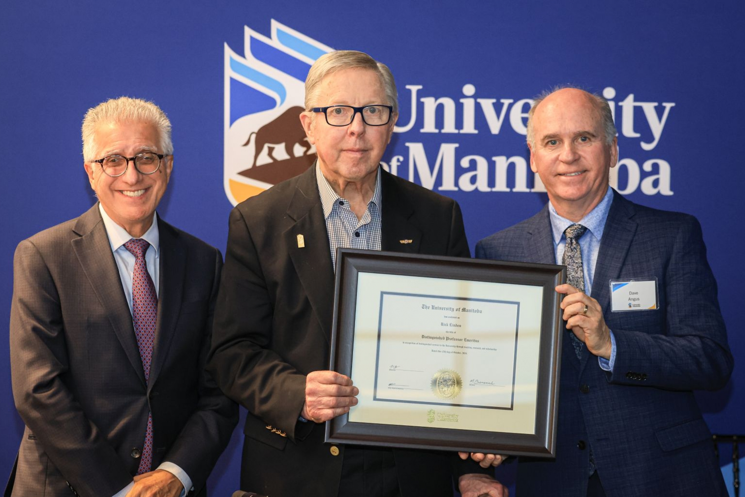 Rick Linden receives emeriti parchment from President Benarroch and Chancellor Angus