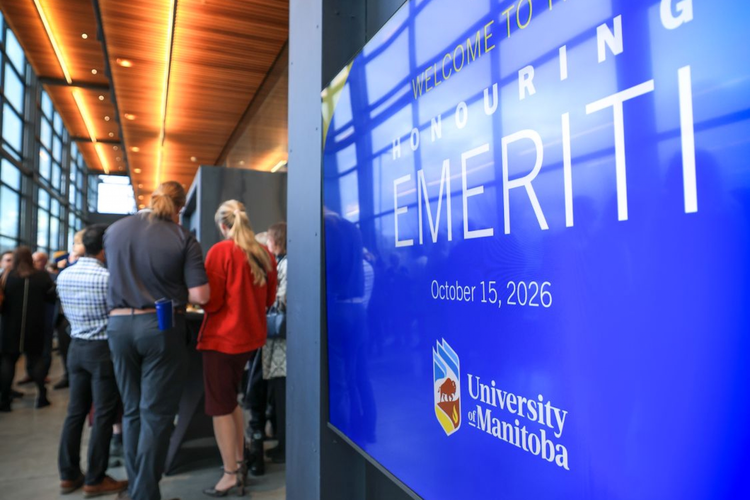 a lit hallway with sign "Honouring Emeriti 2026"
