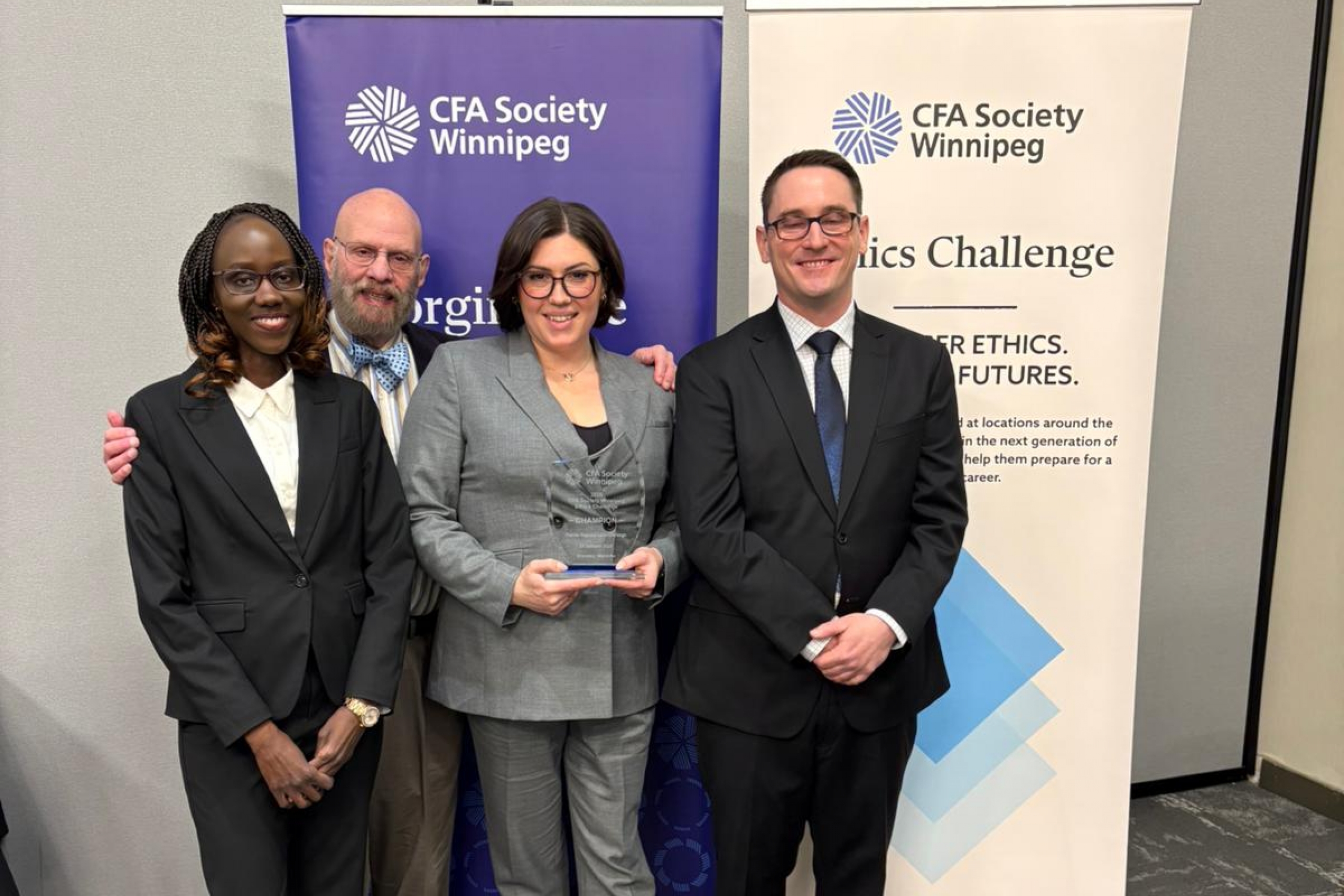 A team poses for a picture with a trophy