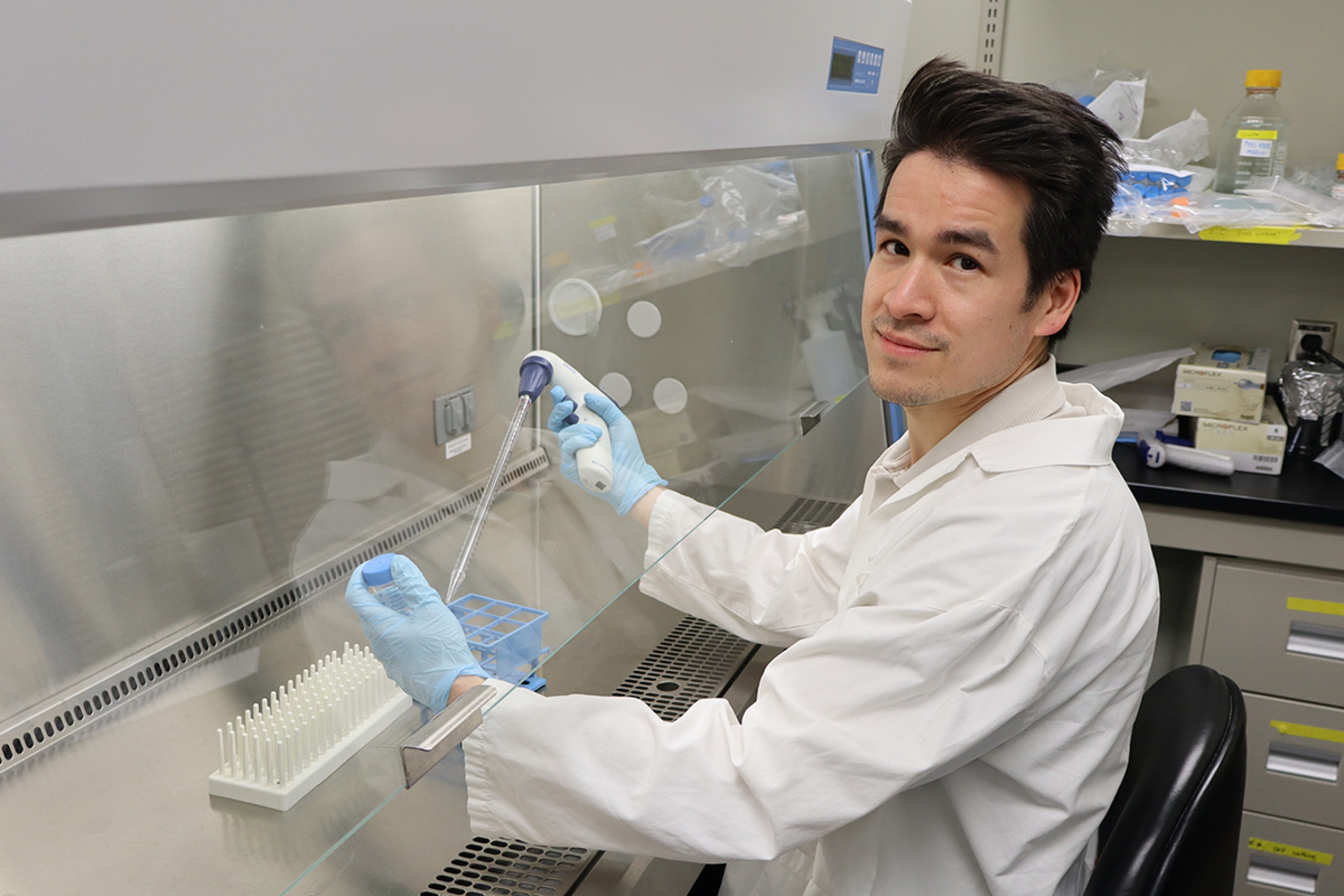 Liam O’Neil preparing a human blood sample in his lab.