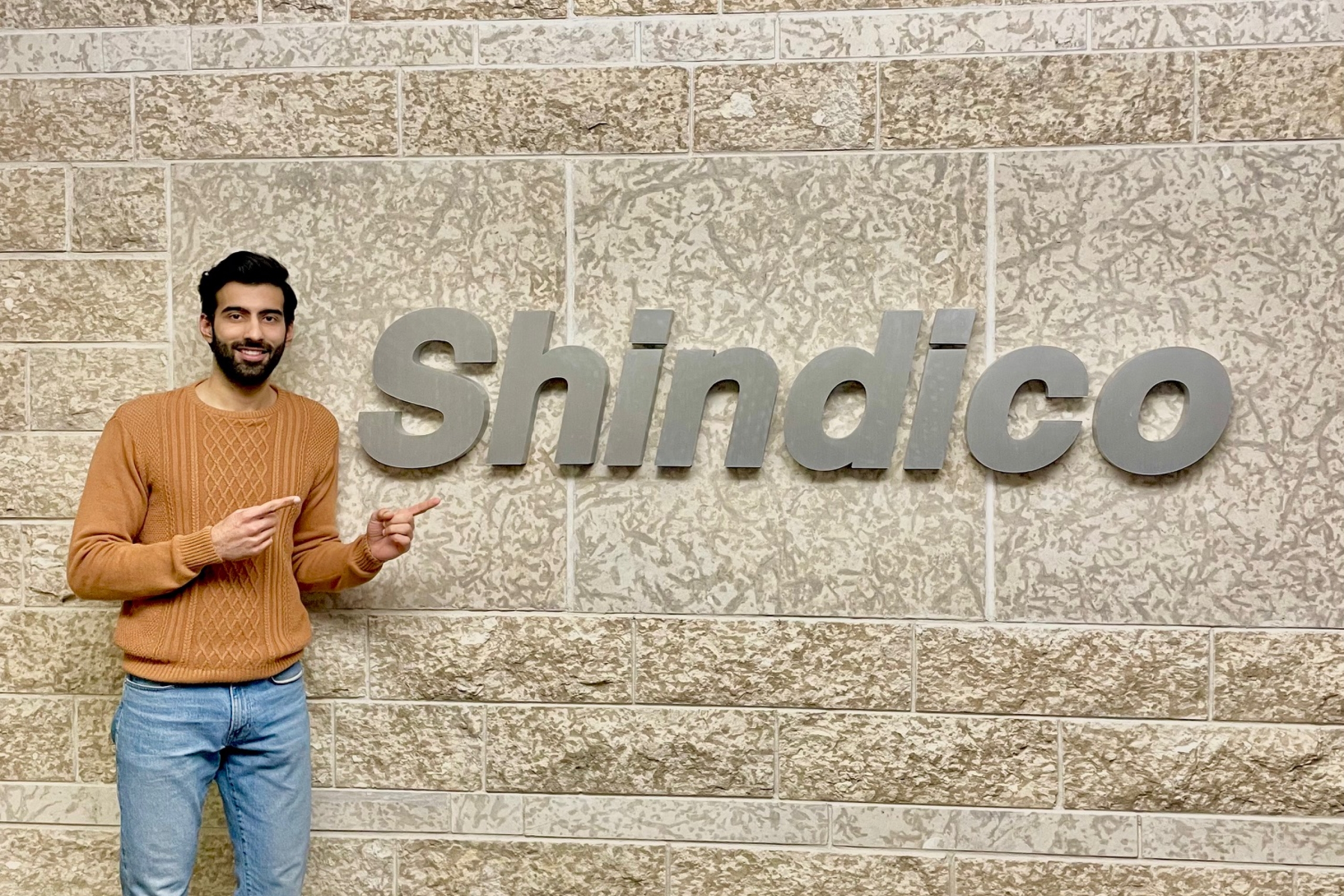 Yashveer Sehrawat stands with a Shindico logo