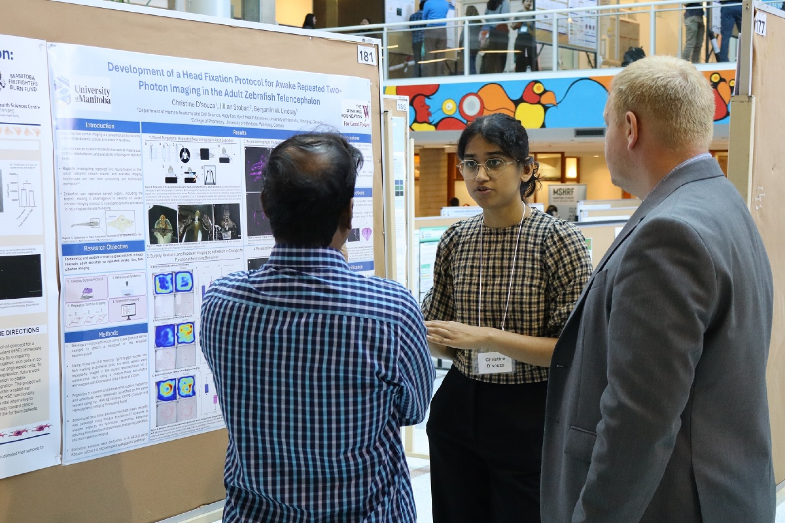 A student explains her research to a group of judges.
