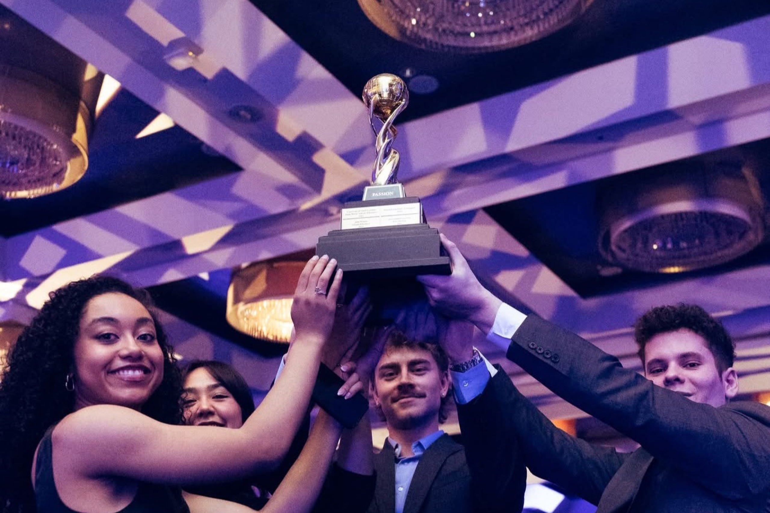 Case Competition Students lift a trophy together