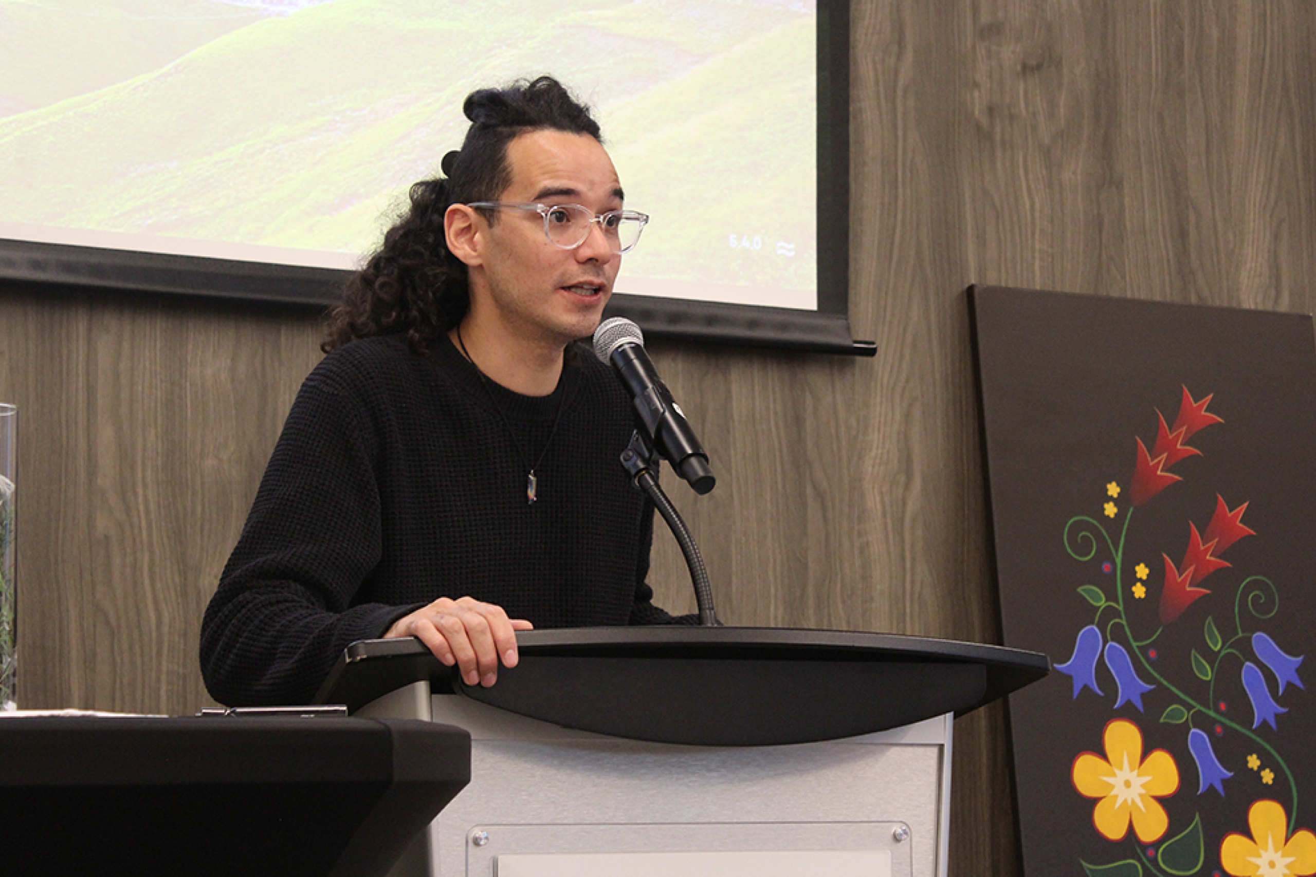 Michael Redhead Champagne speaks at a podium.