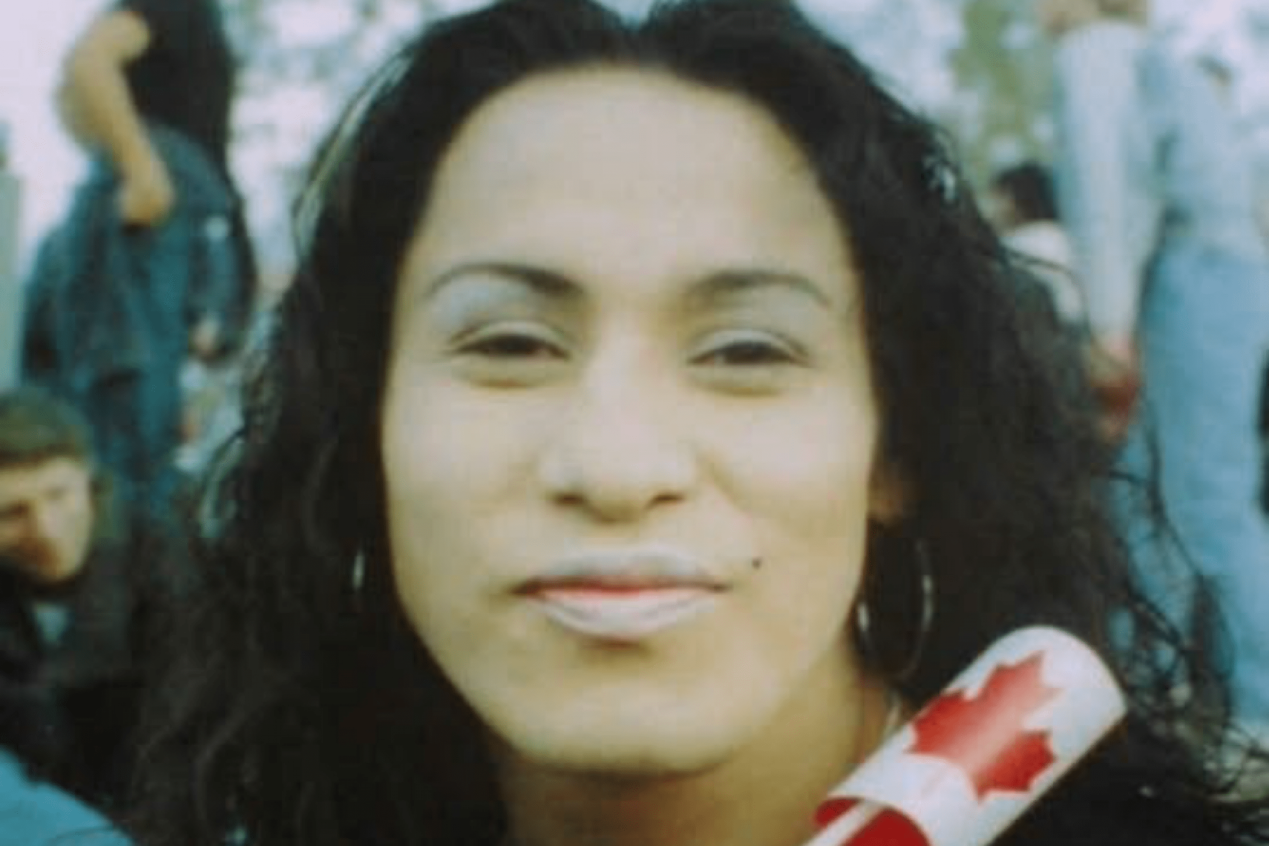 photo of Davis Boulanger, smiling and holding small Canadian flag.