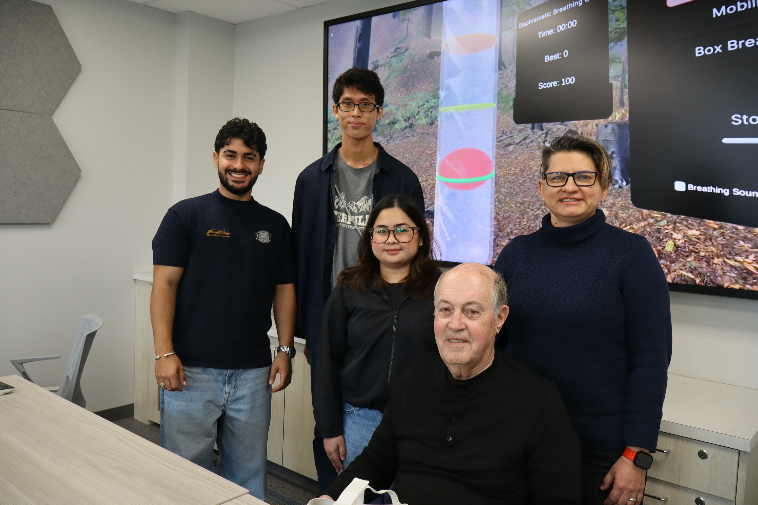 A research group posed with a patient partner. 