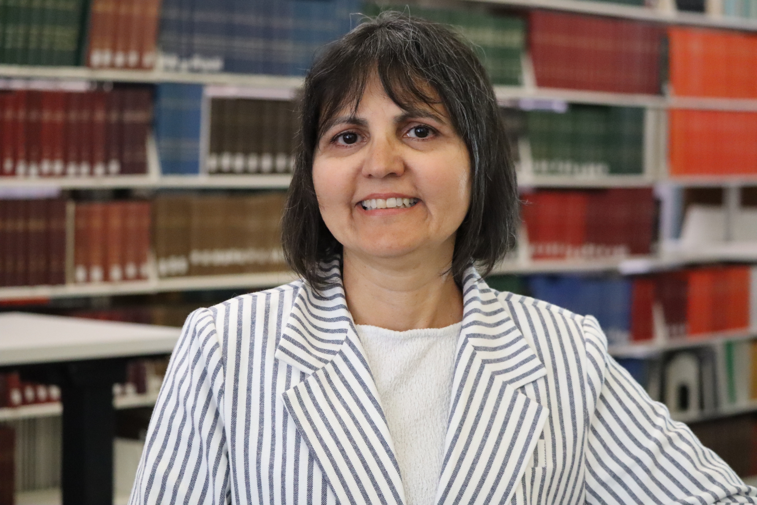 Dr. Mirella Veras in the library at Bannatyne campus.