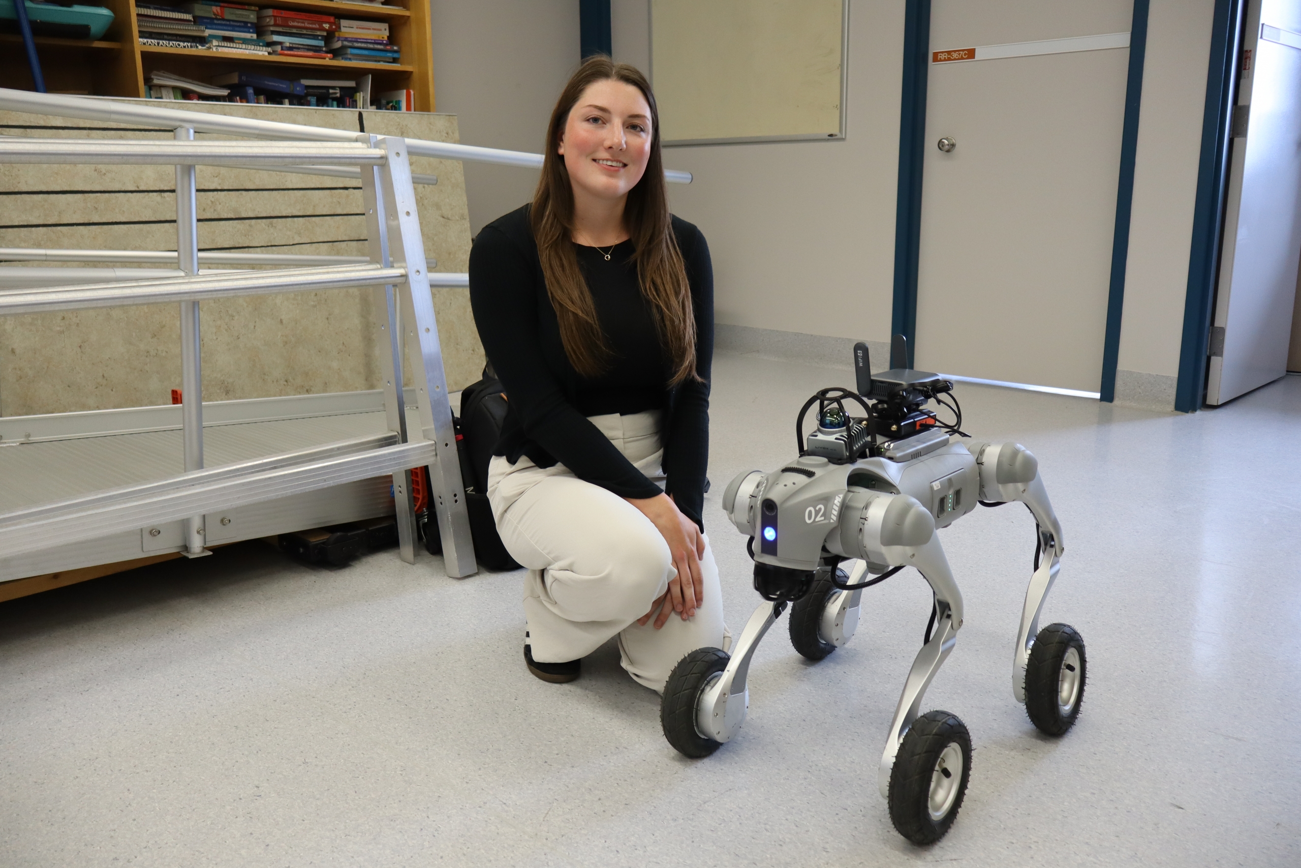 Brooke Peterson poses with a robot dog.