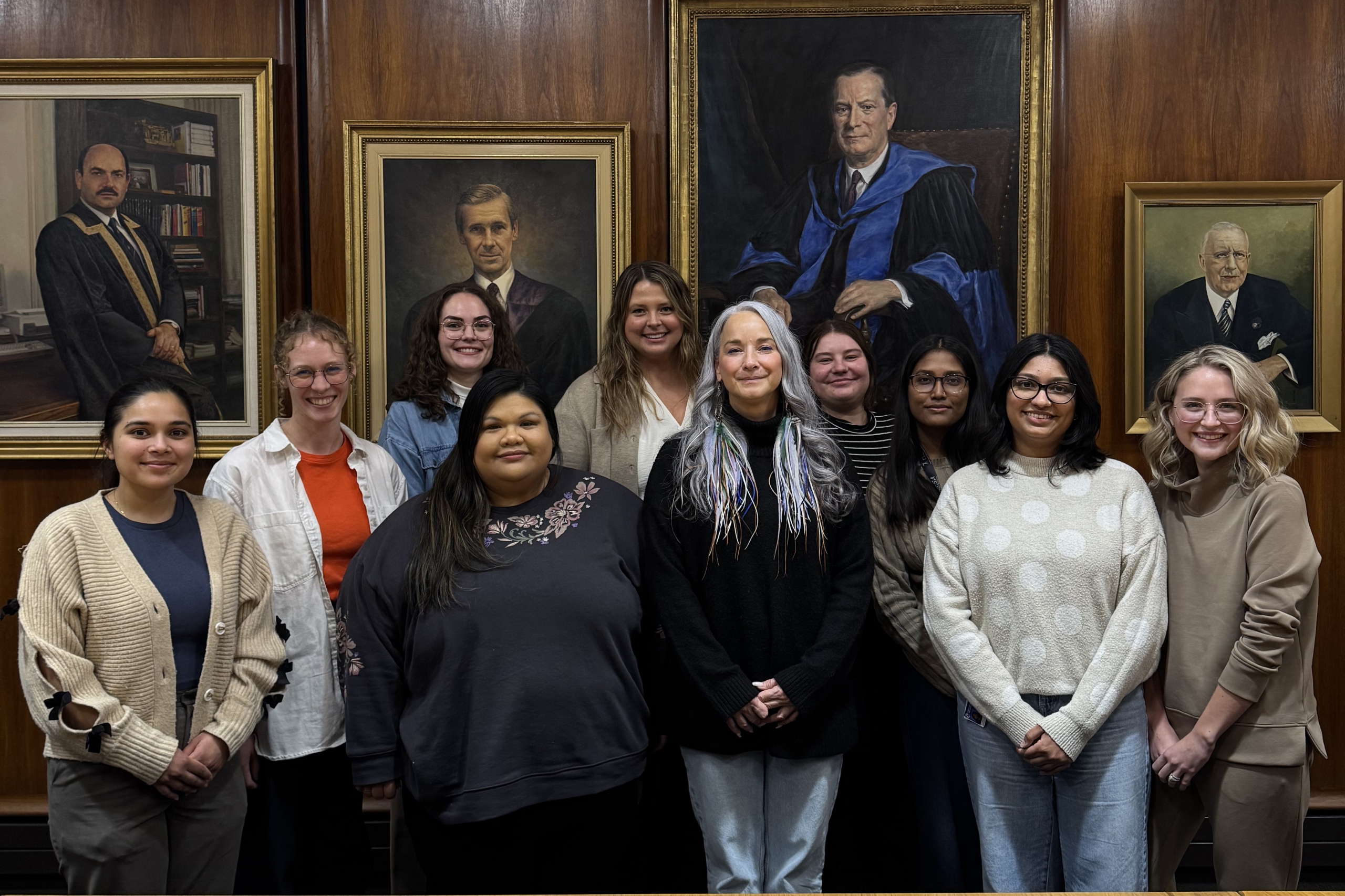 A group of students from WISDOM stand with Nahanni Fontaine, Minister of Families.