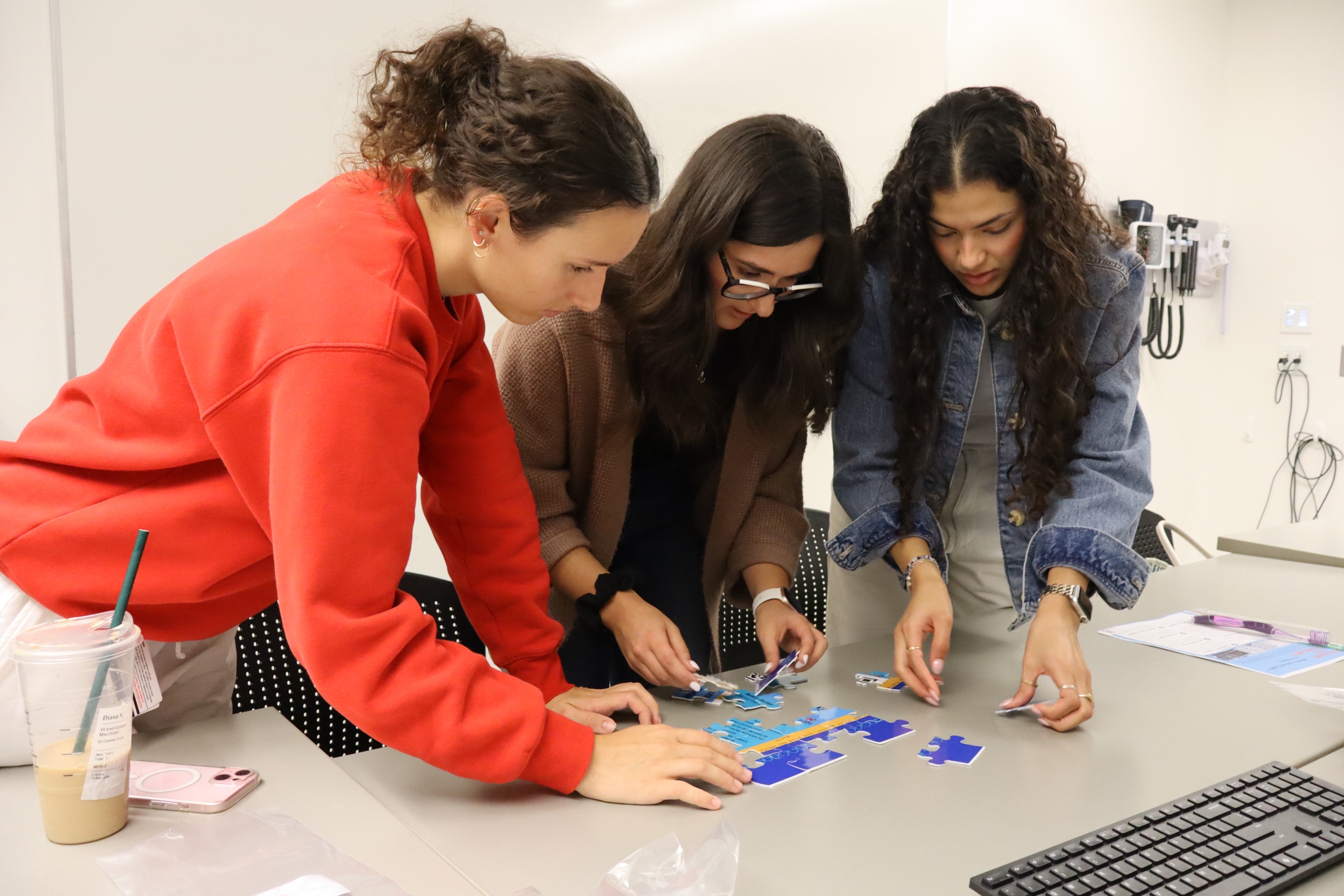 Three students working on a puzzle.