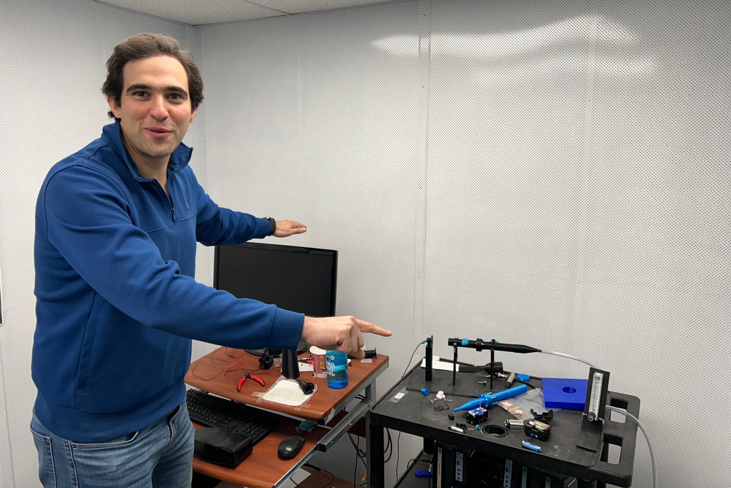 A man points at a device.