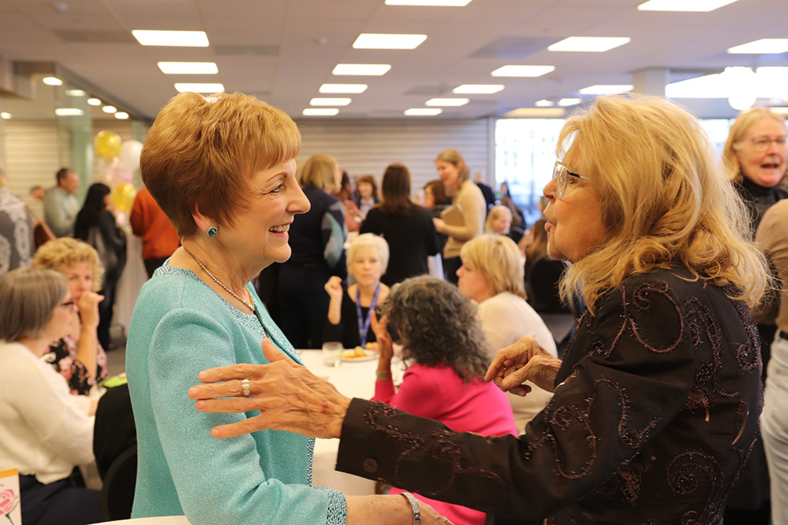 Two women greeting eachother.