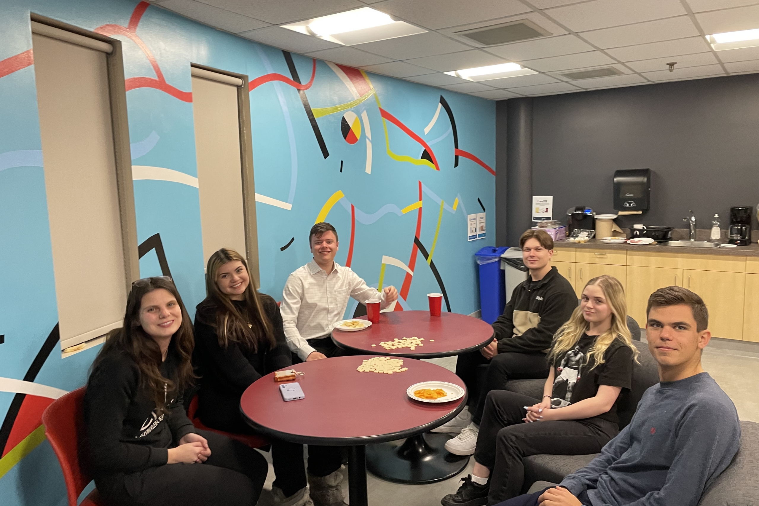 Students sit at a table in the IBEP lounge